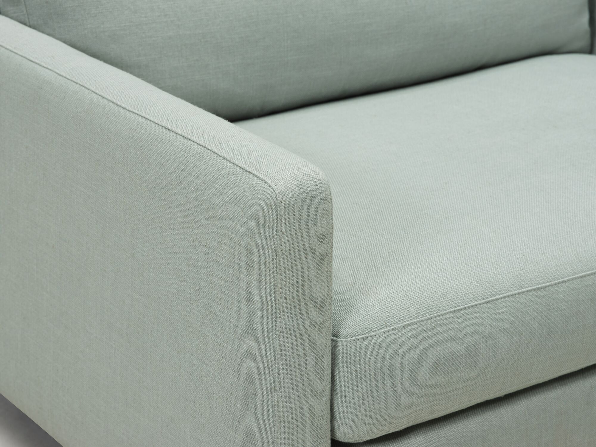 Arm detail view of teal armchair