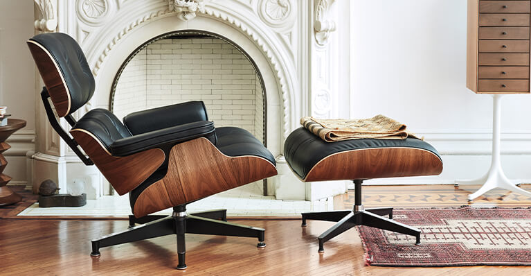 Herman Miller iconic eames lounge chair and ottoman are displayed in detail in a living room. Link to herman miller sale page