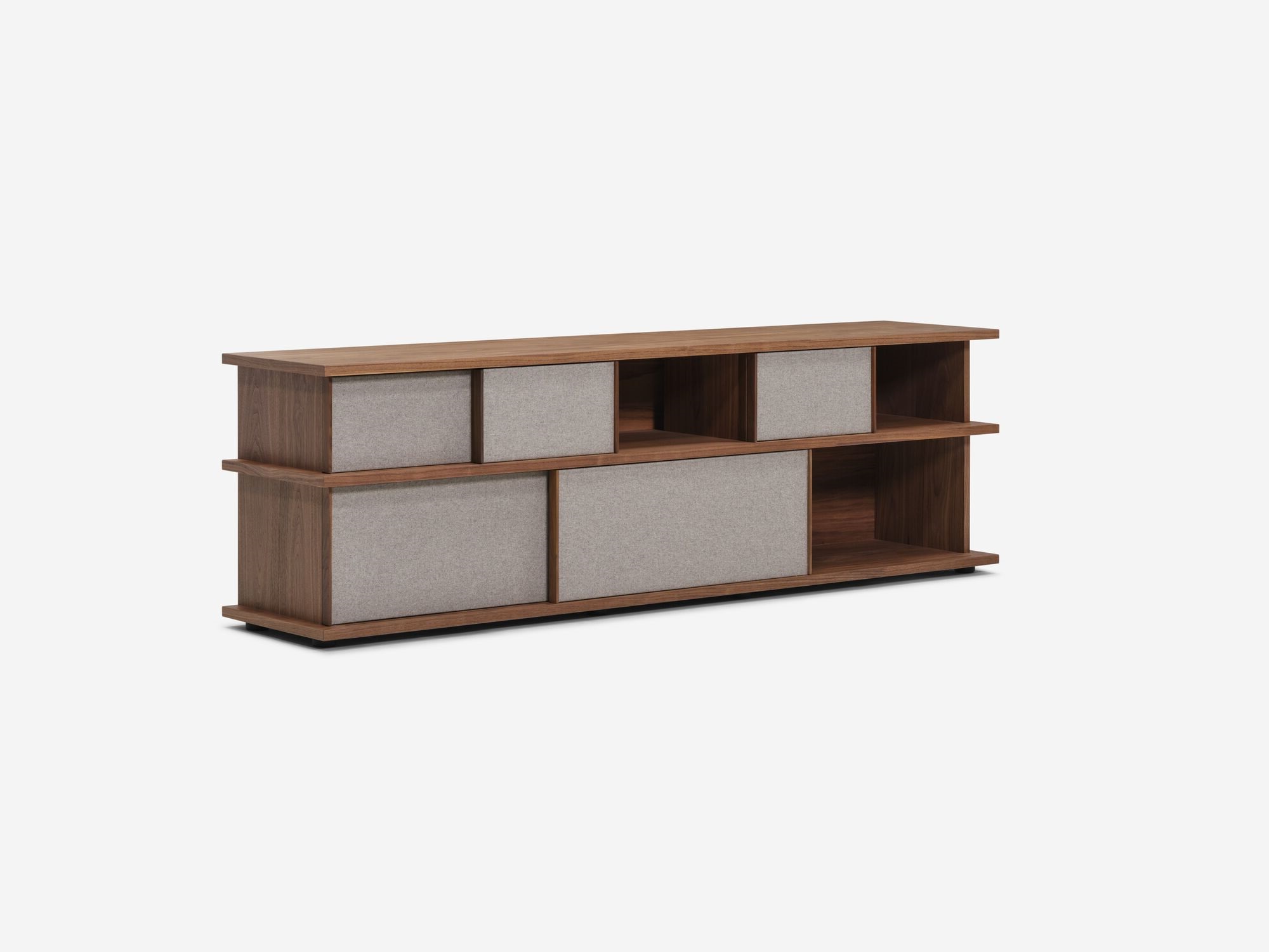 Angled view of the Plank tall modern media console in walnut with open drawers and fabric panels