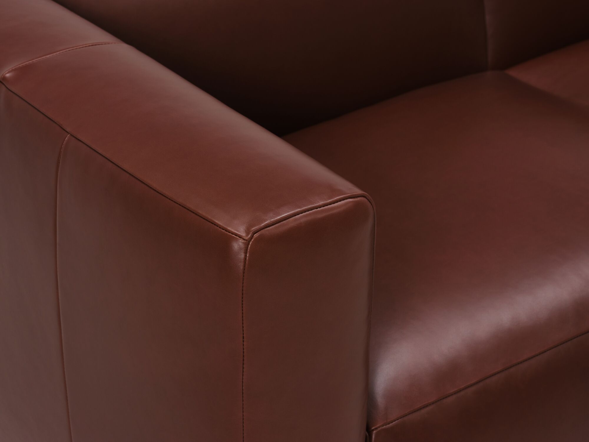 Dark brown leather sofa detail arm view