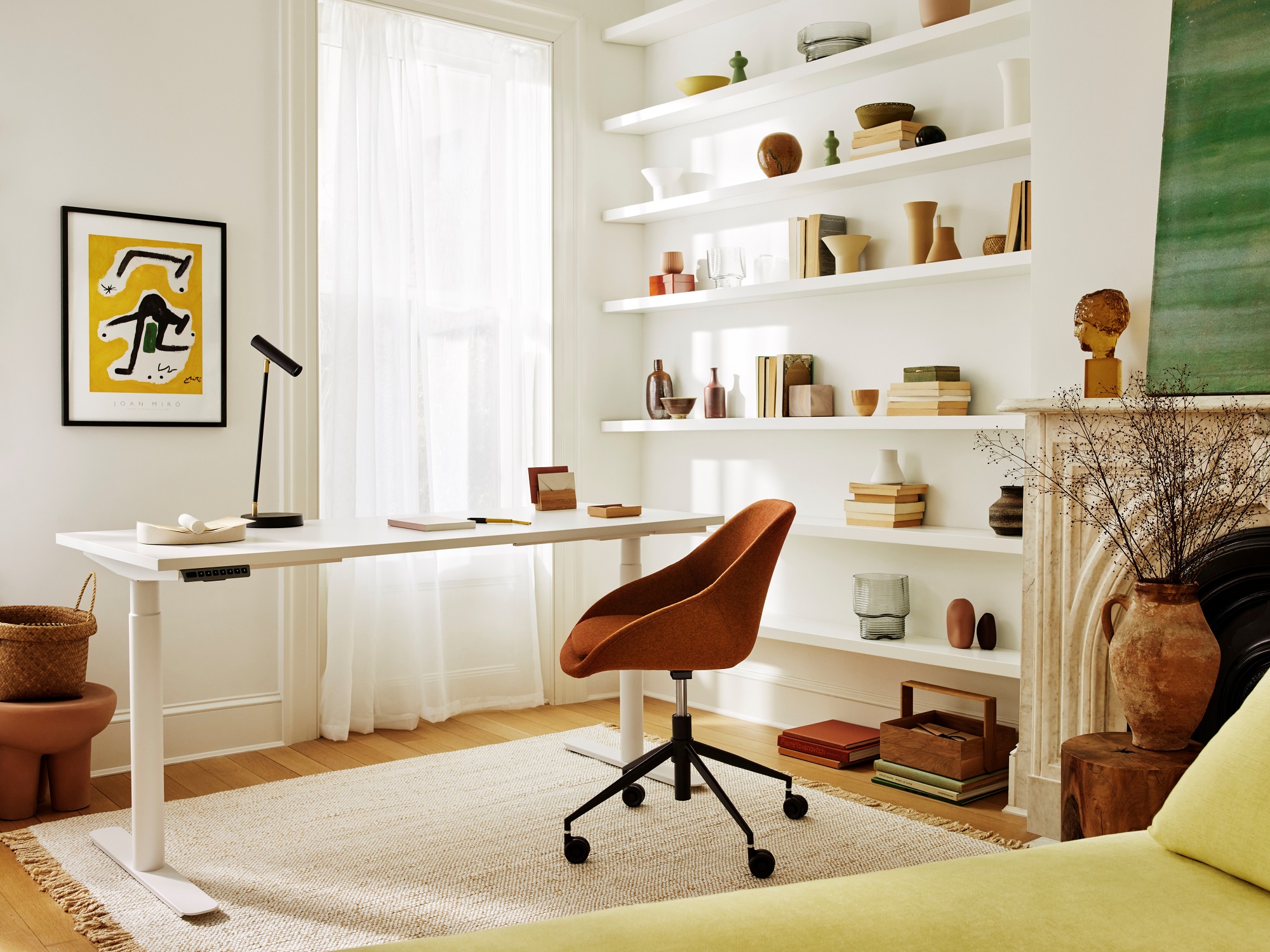 White sit stand desk with red upholstered office chair in modern den