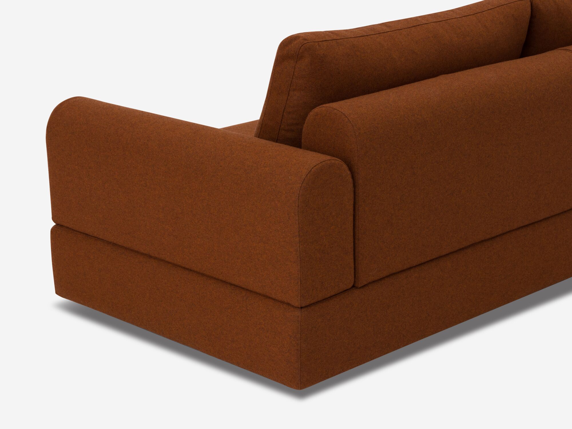 Back angle detail view of burnt orange sectional sofa