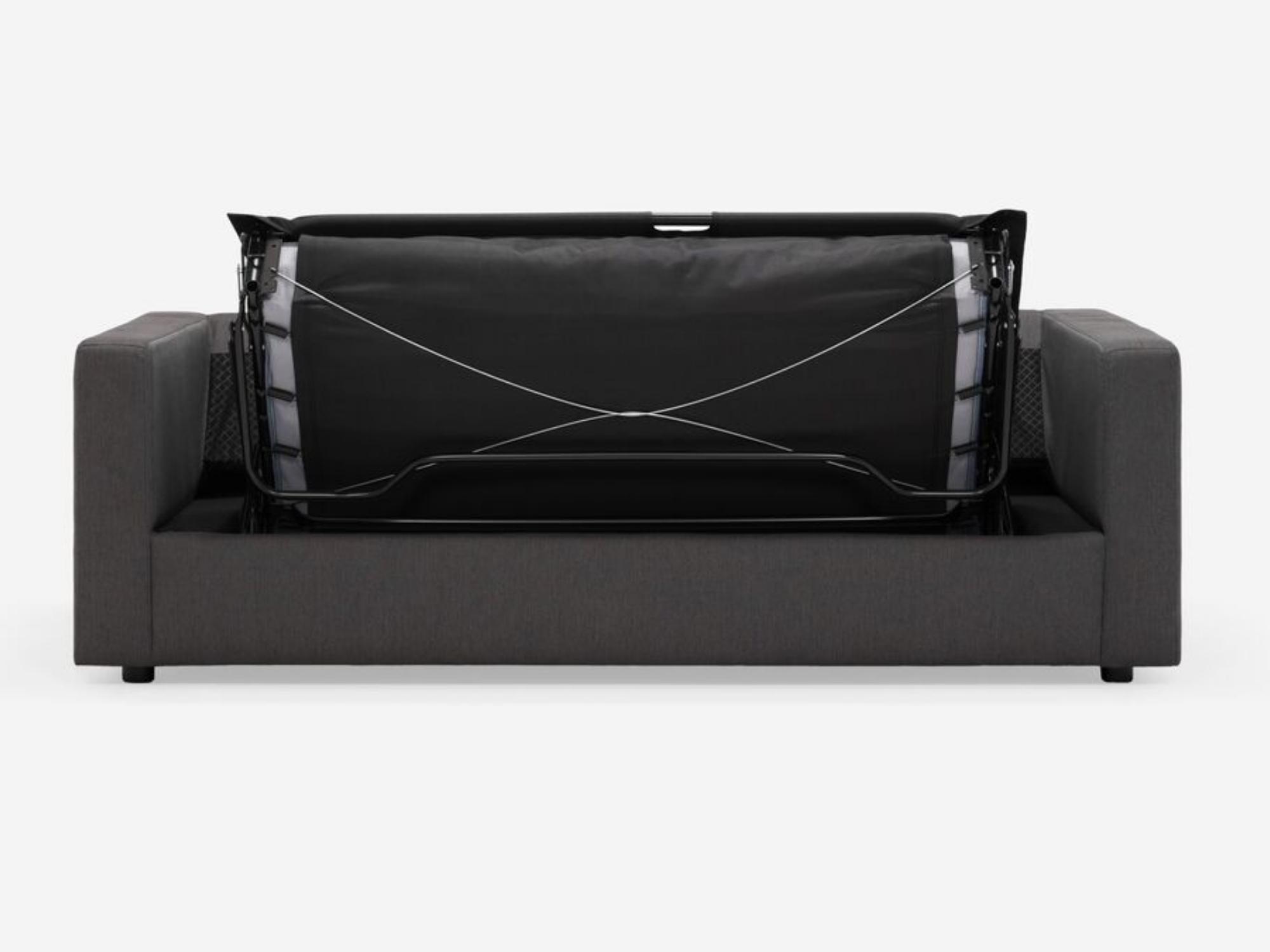 Front view of the Solo sofa bed in dark grey fabric with bed partially unfolded