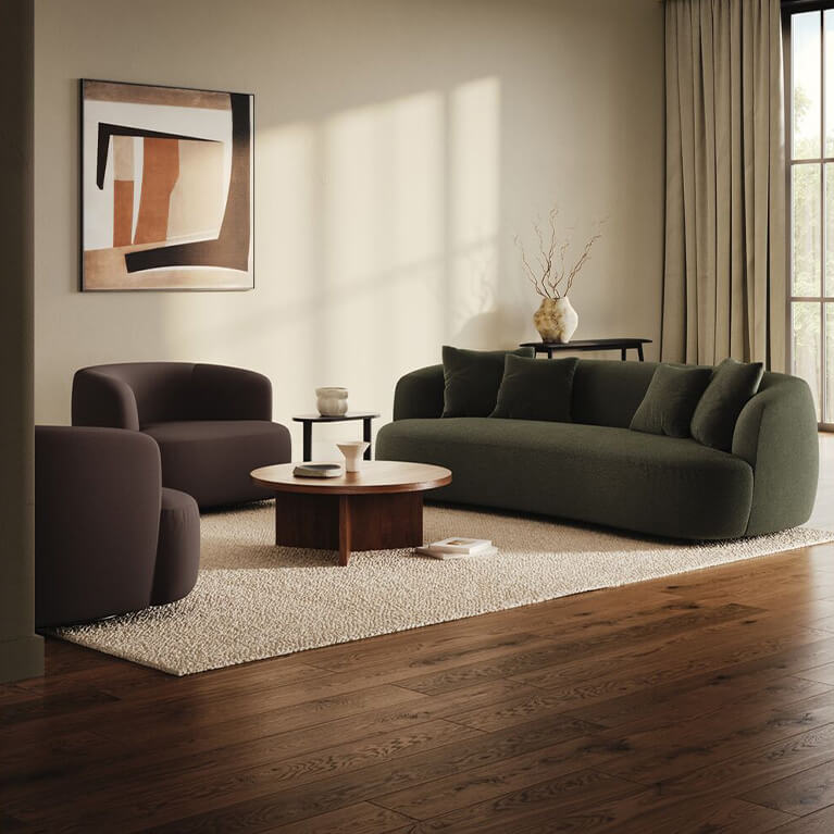 Two chairs and large sofa are displayed in a modern living room setting. Link to seating category