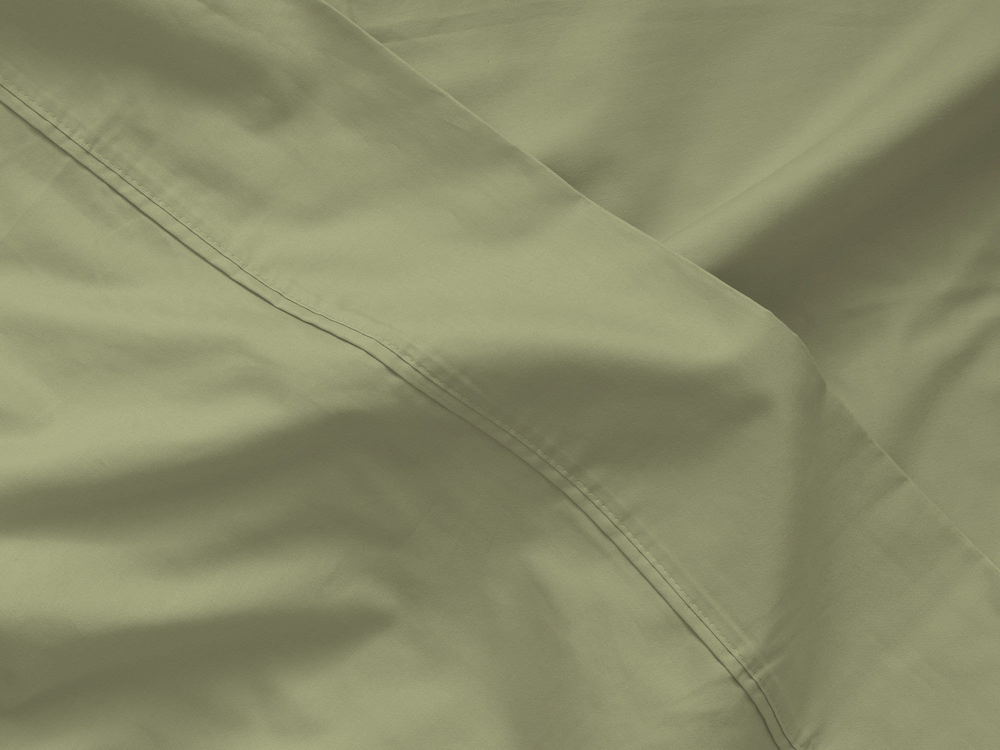 Detail view of organic cotton bed sheets in green