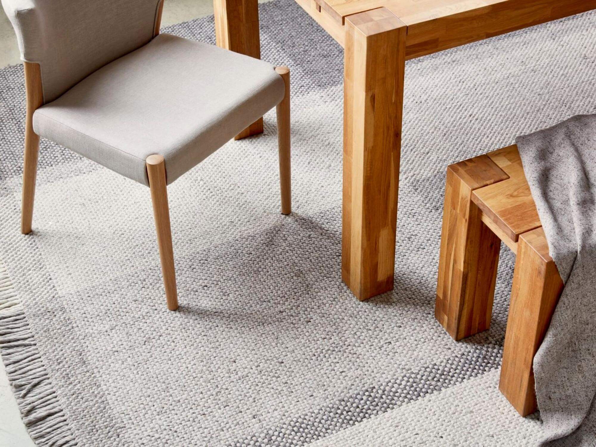 Wool tartan rug under solid oak dining room table and matching chairs