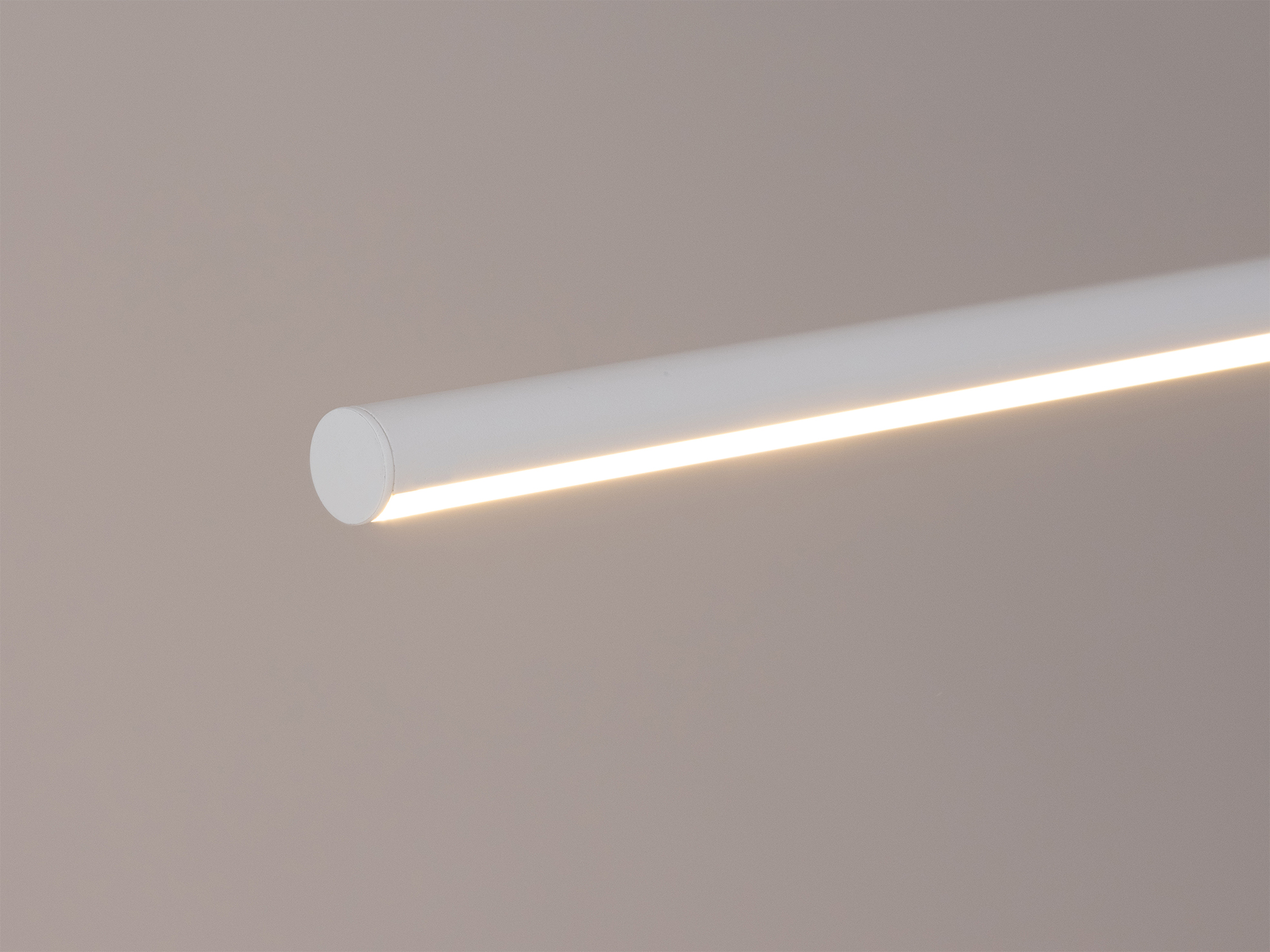 Detail view of the Slimline pendant light in white with light on