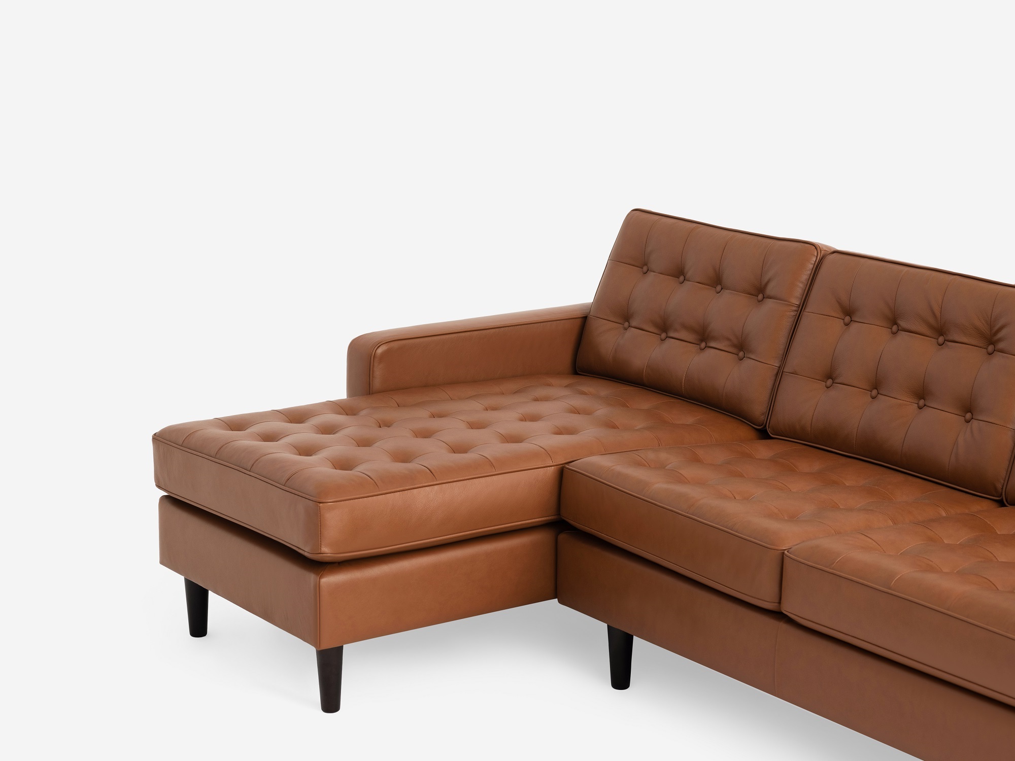 Detail angled view of the  Reverie modern sectional sleeper sofa in brown leather with left hand facing chaise