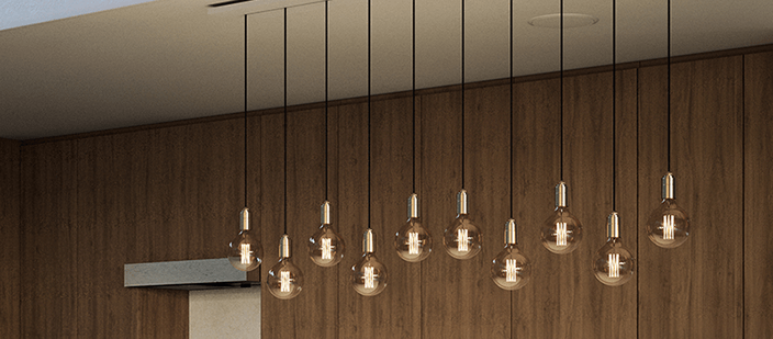 Edison bulb pendant lights against a walnut paneled wall