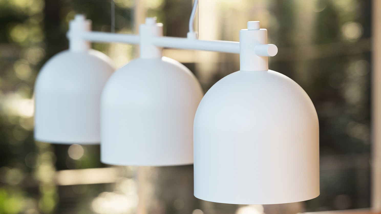 White pendant lighting in a bright dining room