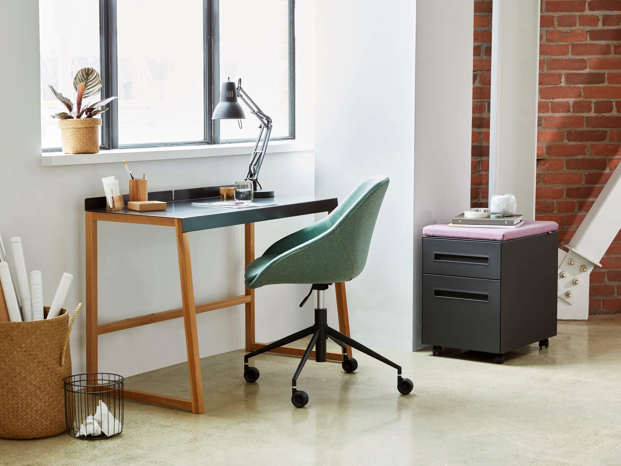 Blue upholstered office chair at small desk in modern office