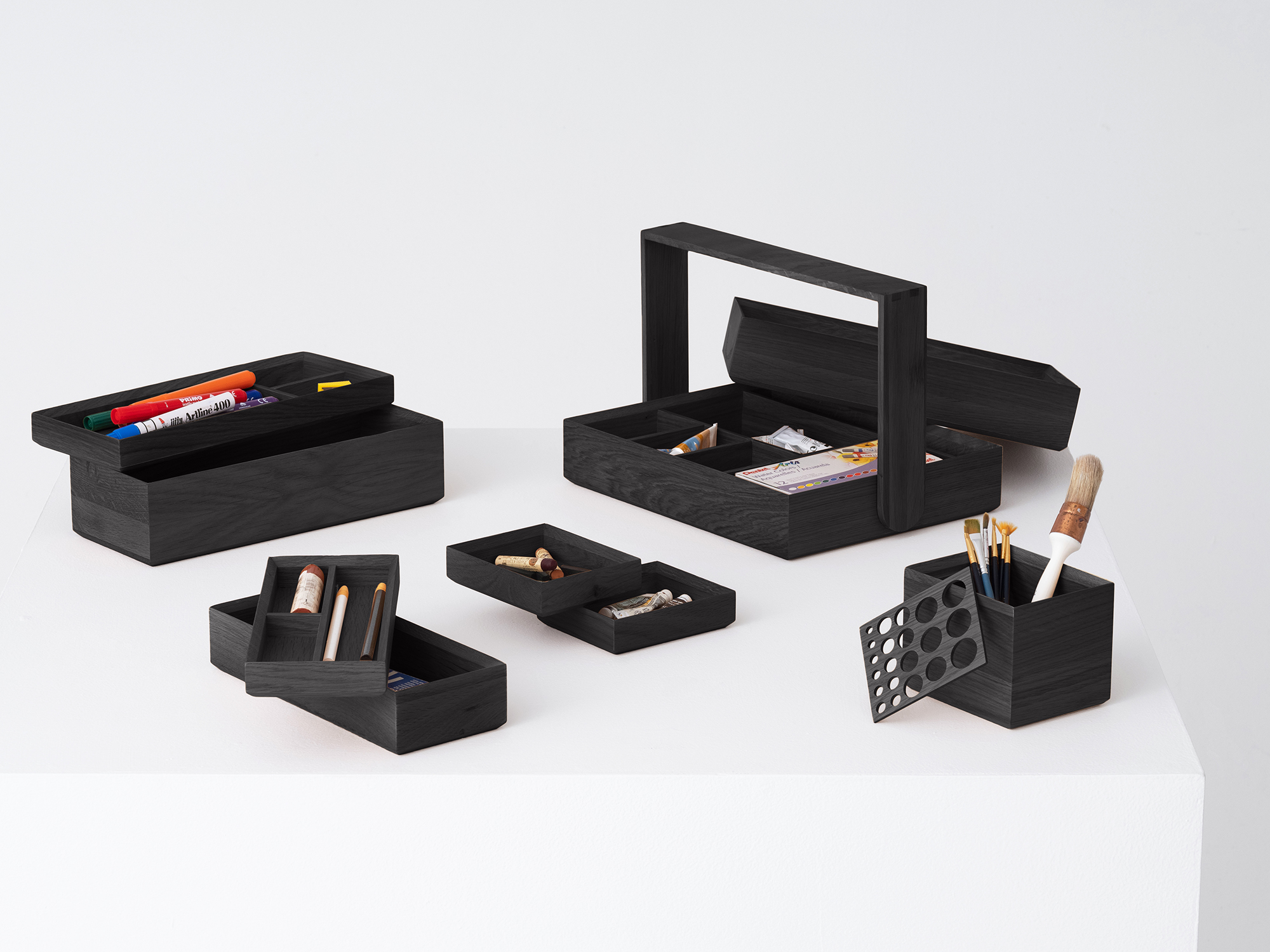 The entire Draft wooden office organizer collection unstacked in black oak