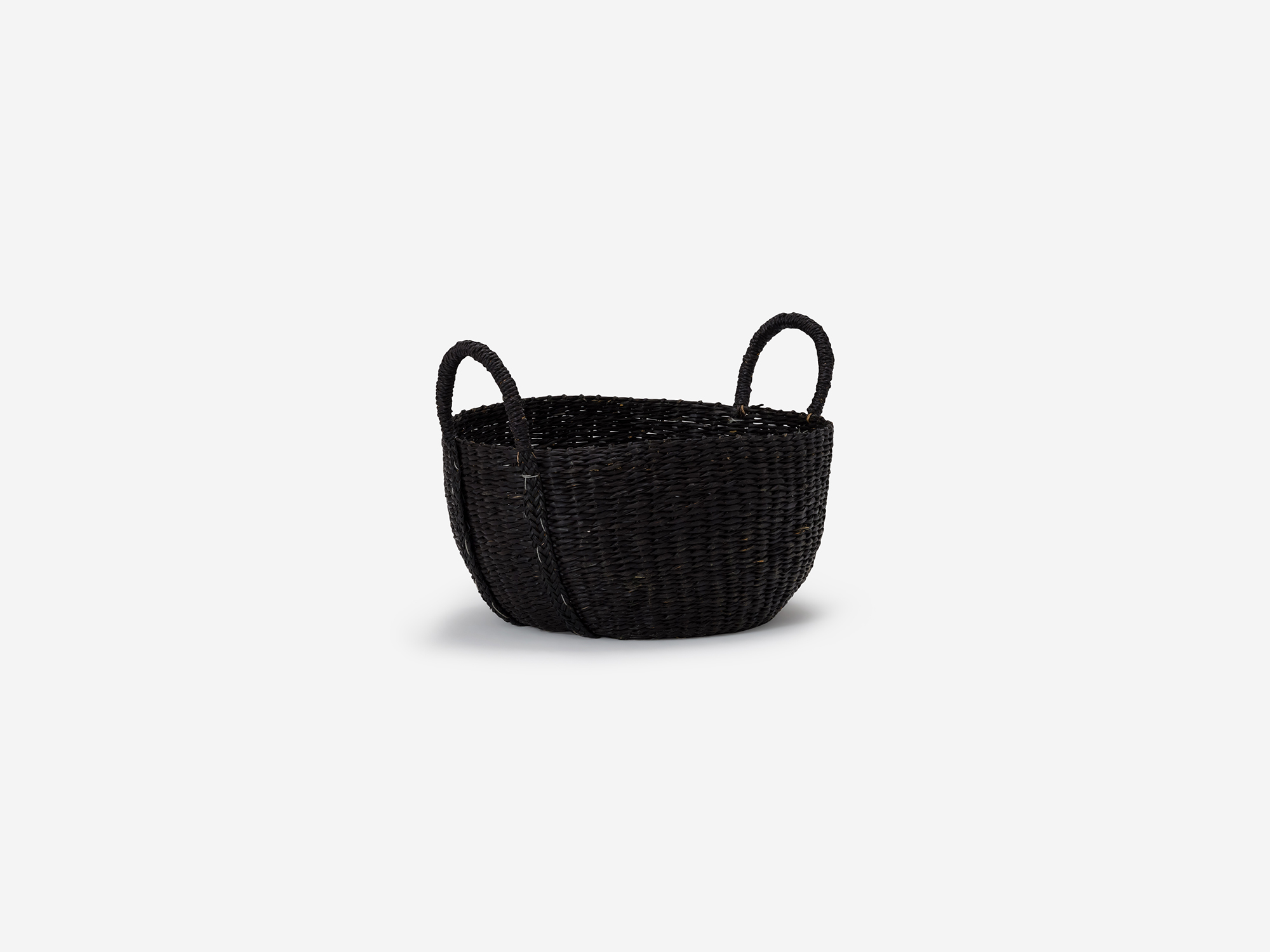 Angled view of small black woven basket with loops