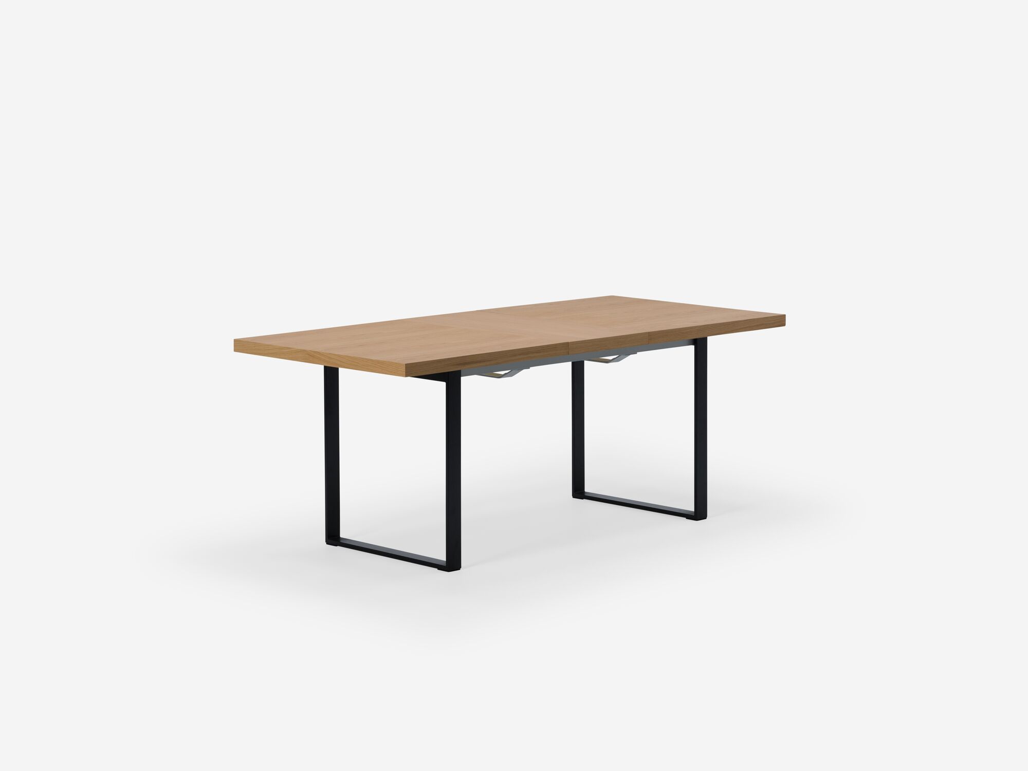 Expandable dining table with black legs, oak top and one leaf corner view