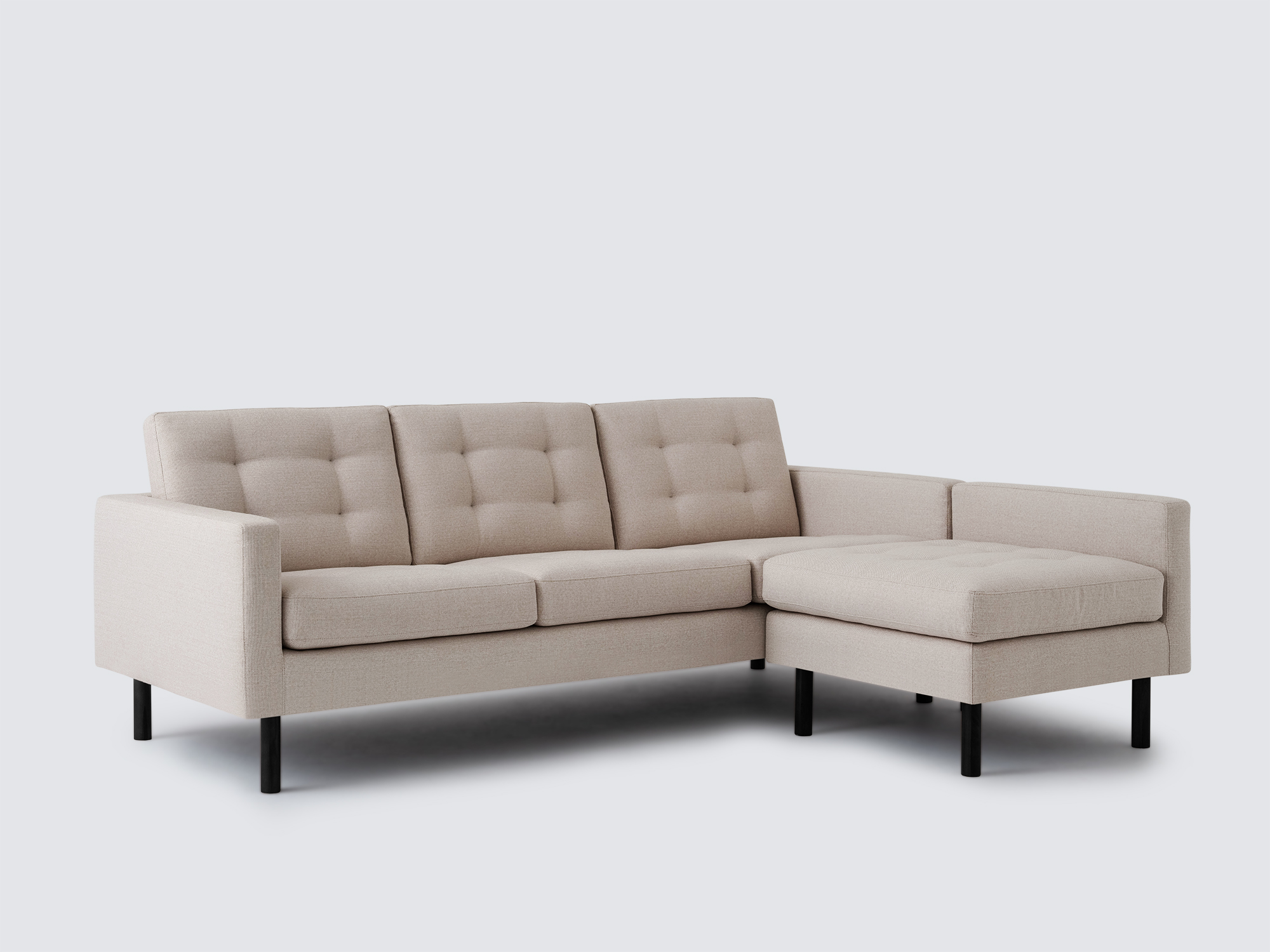 Angled view of the Joan right hand sectional upholstered in beige fabric