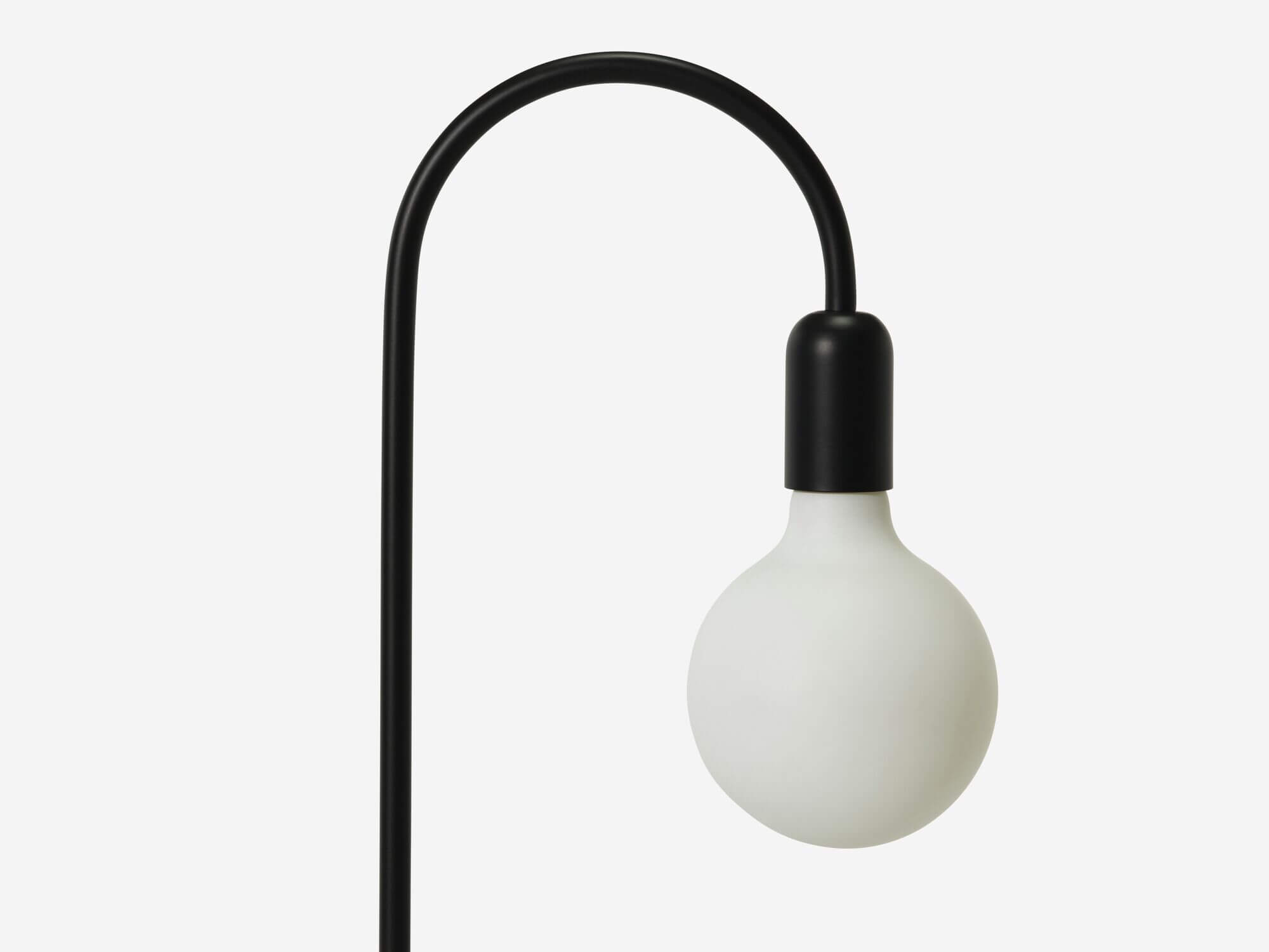 Detail bulb view of black curved table lamp