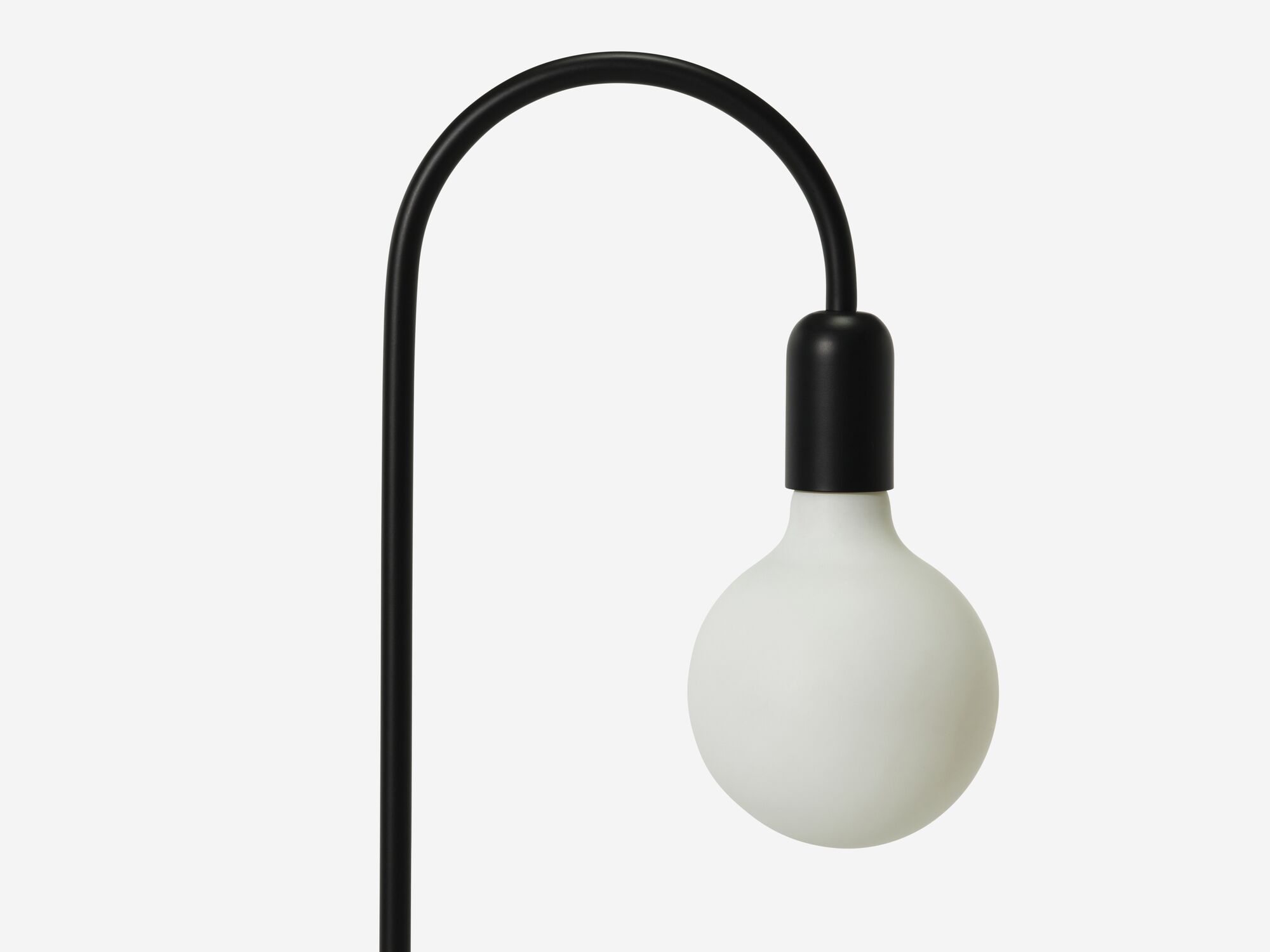 Detail bulb view of black curved table lamp