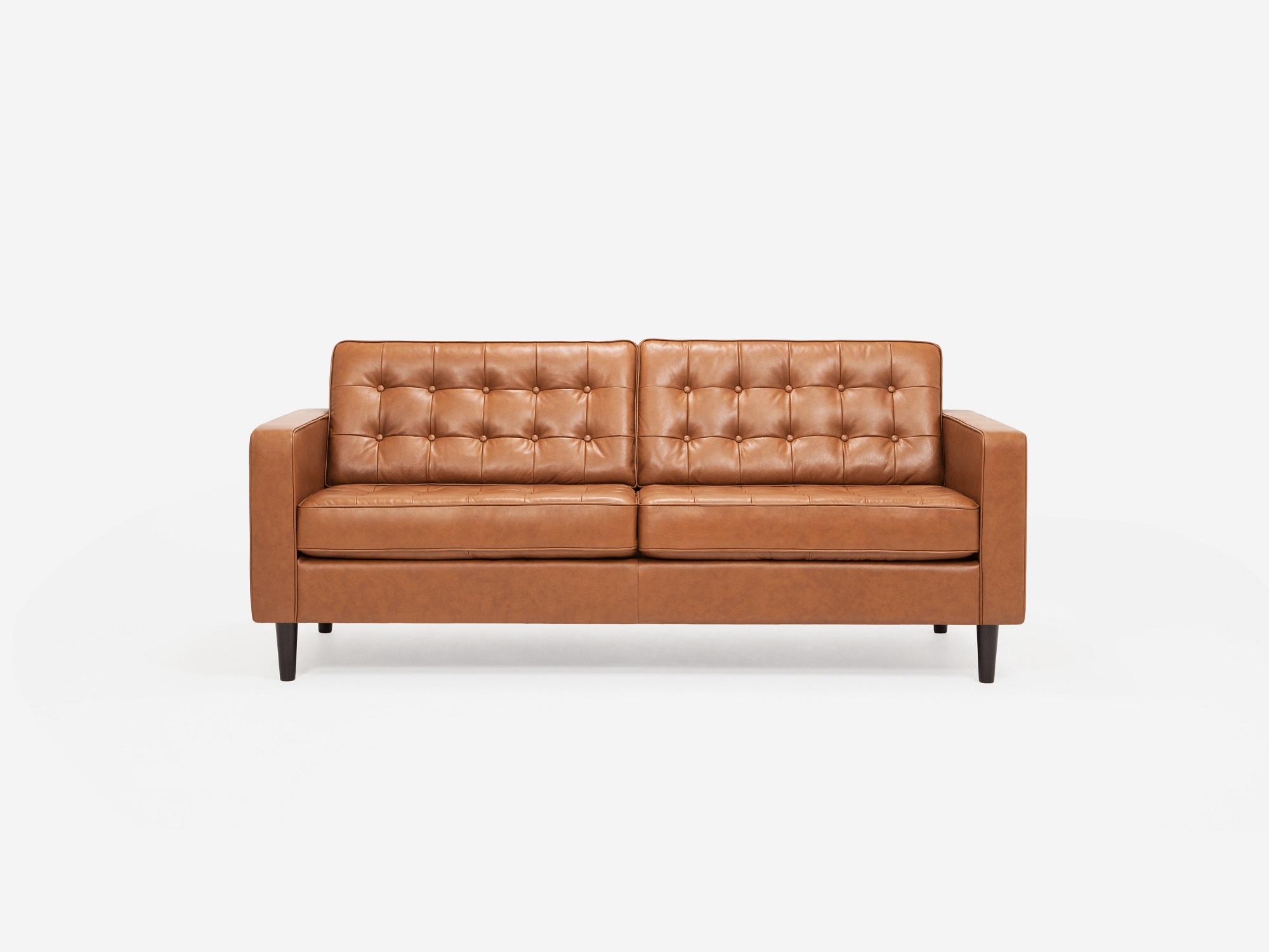 Front view of leather tufted apartment sofa with black ash legs