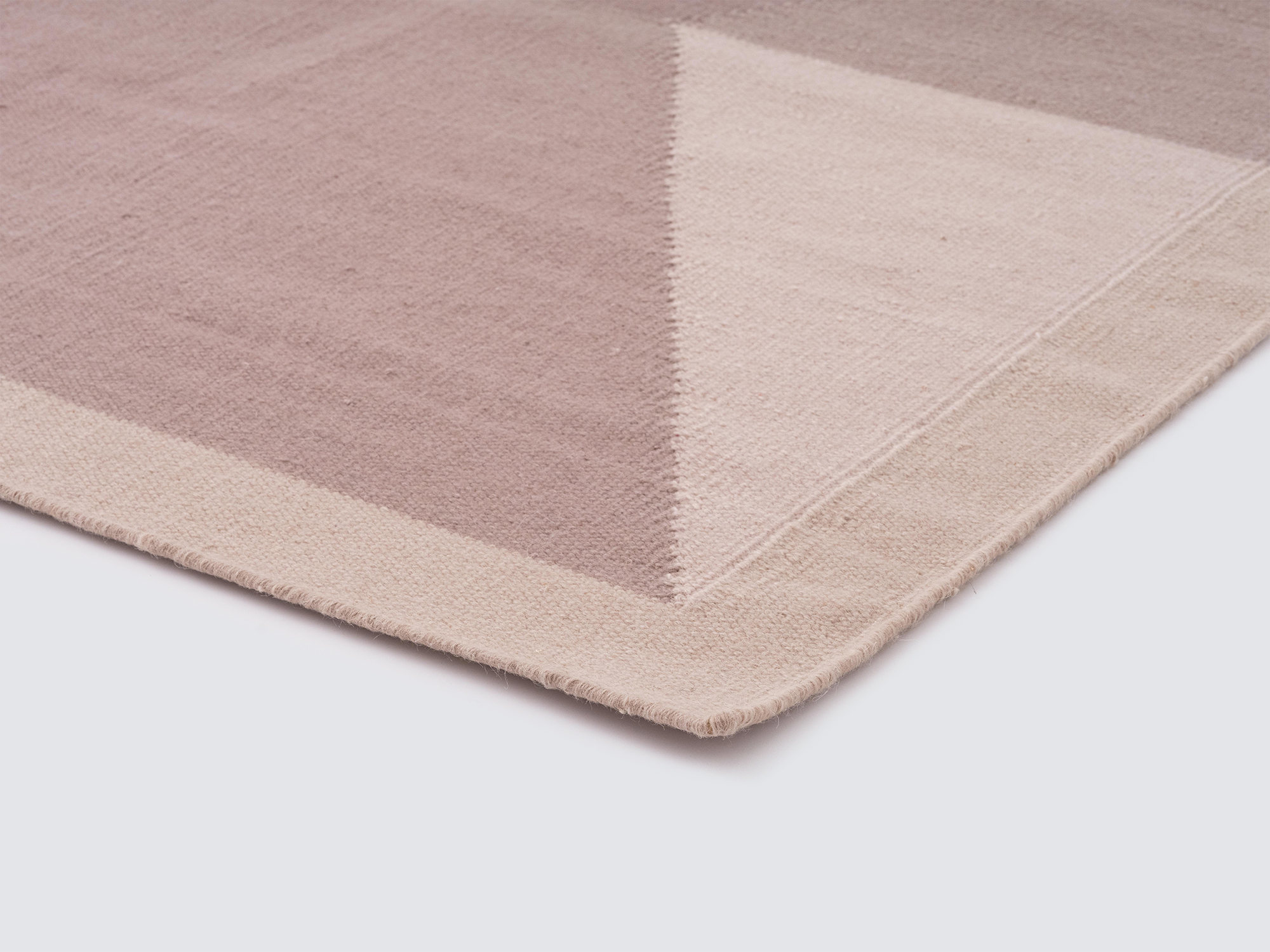 Detail view of the modern handwoven wool rug in taupe