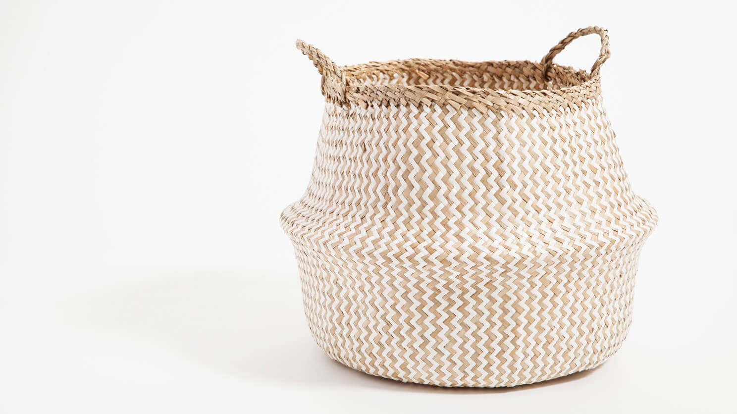 Detail view of the large beige and white woven Trundle basket