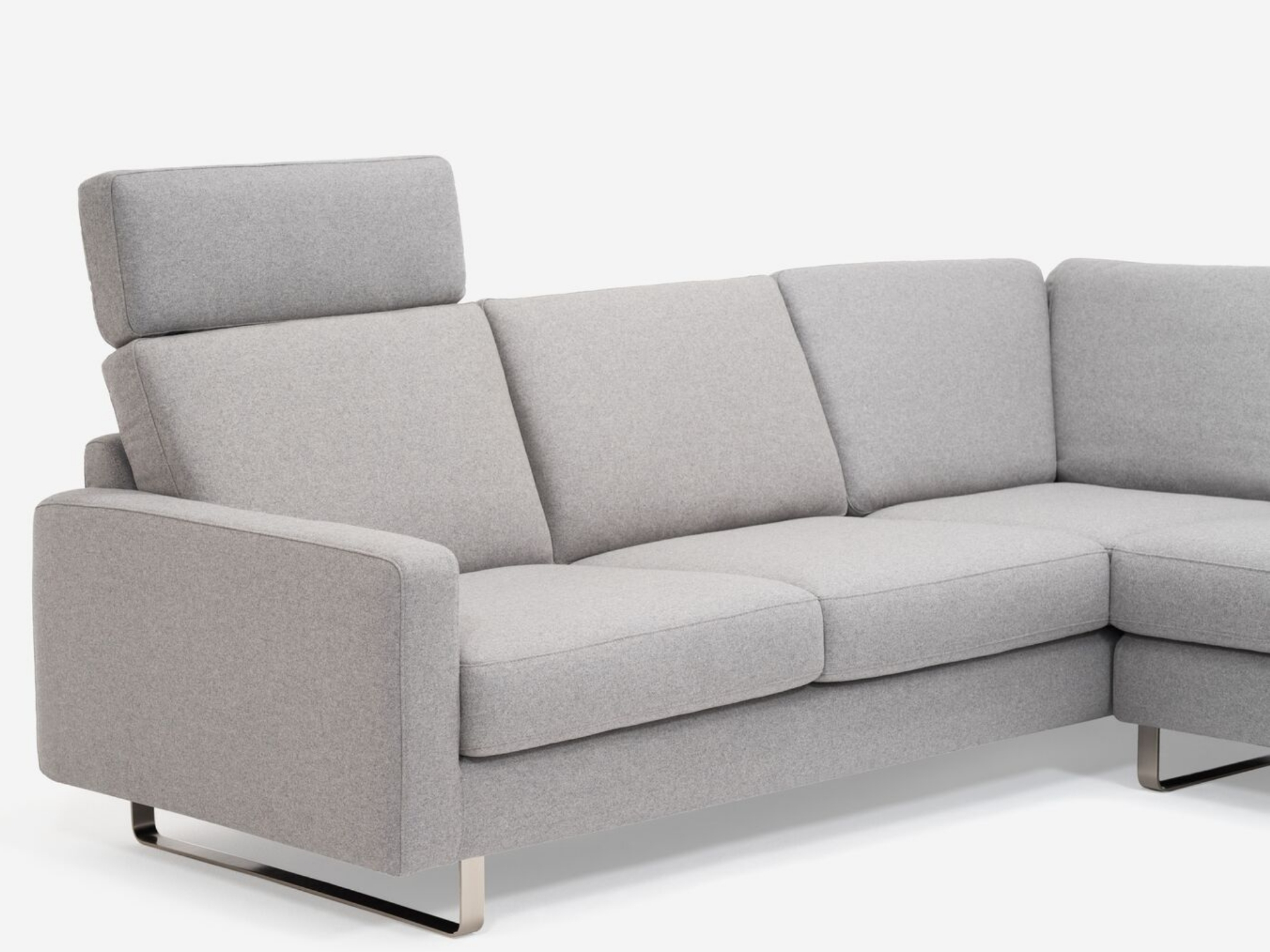 Left arm detail view of grey 2-piece sectional sofa with headrest