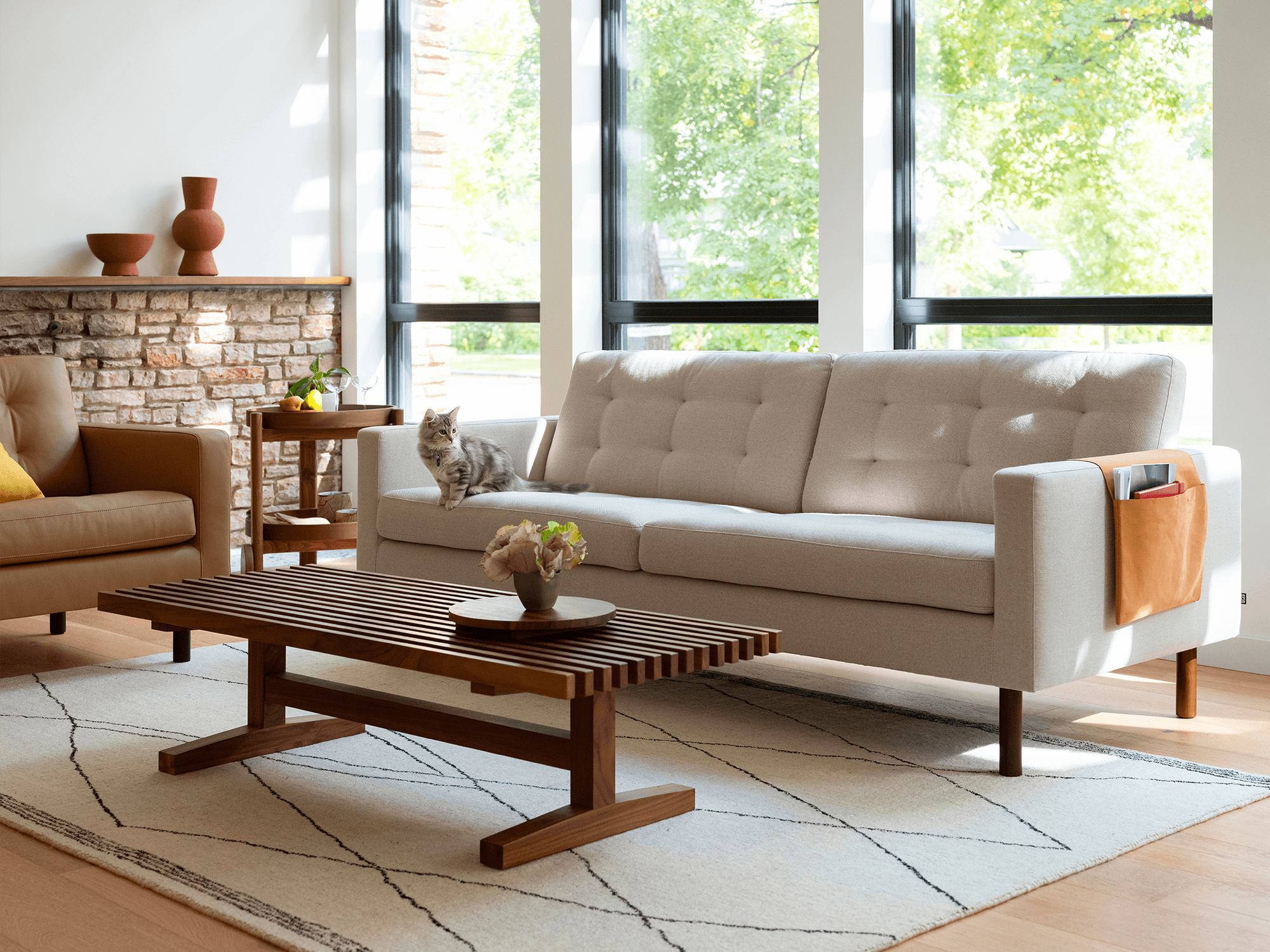 Beige rug with black diamond stripes in a neutral colored living room