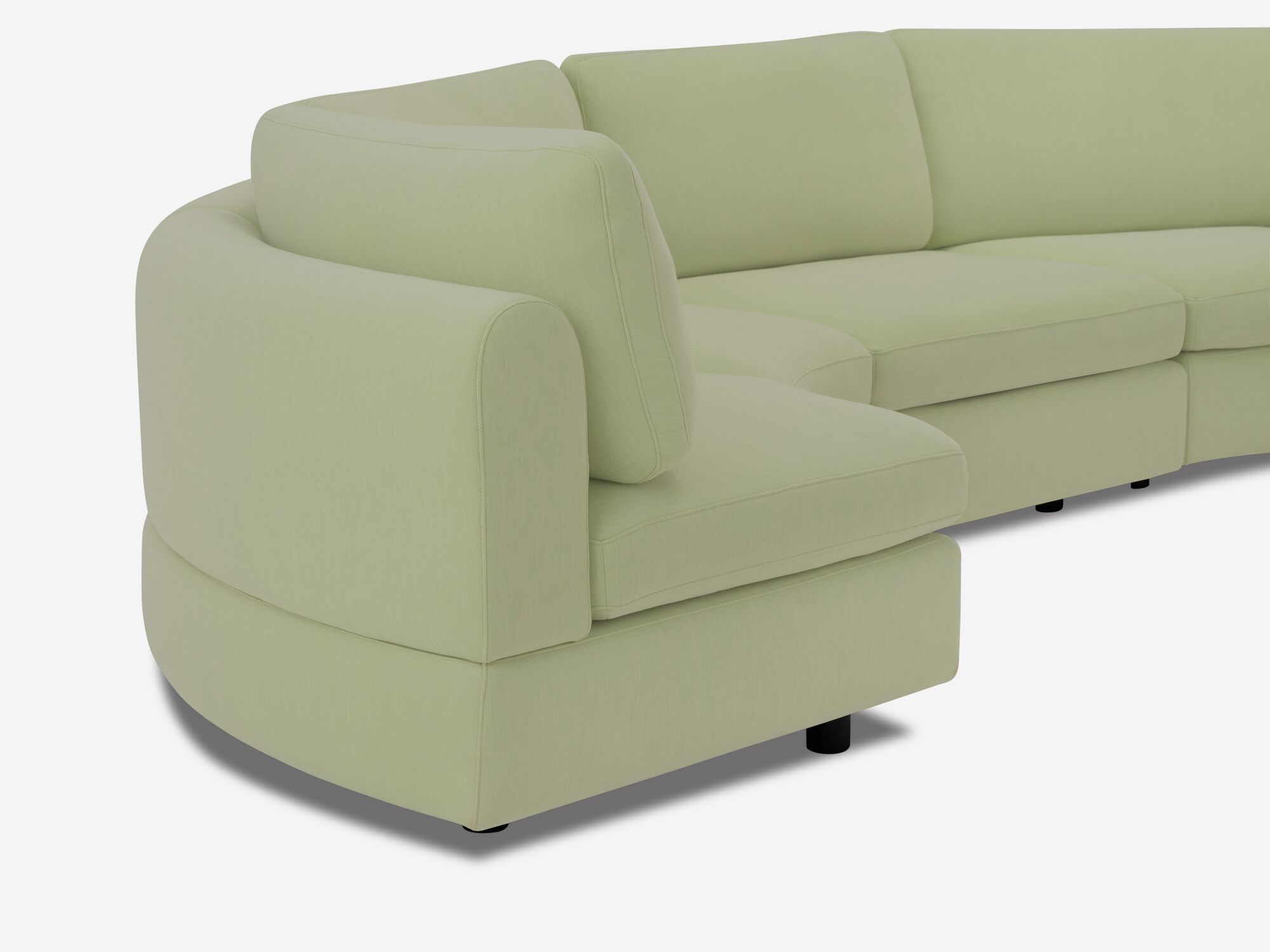Back detail view of light green curved sectional sofa