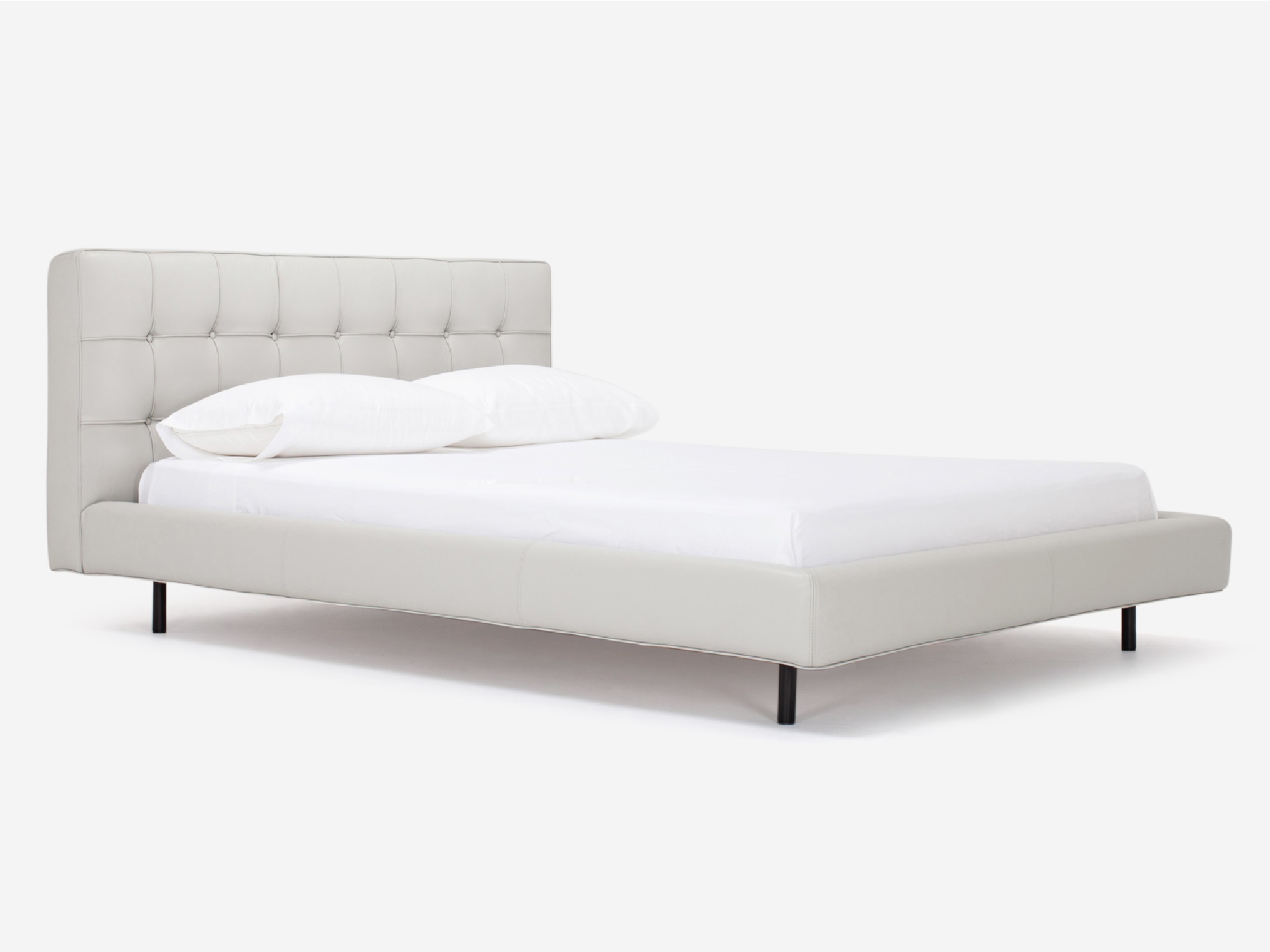 Corner view of Winston, the mid century modern bed, in pale grey leather