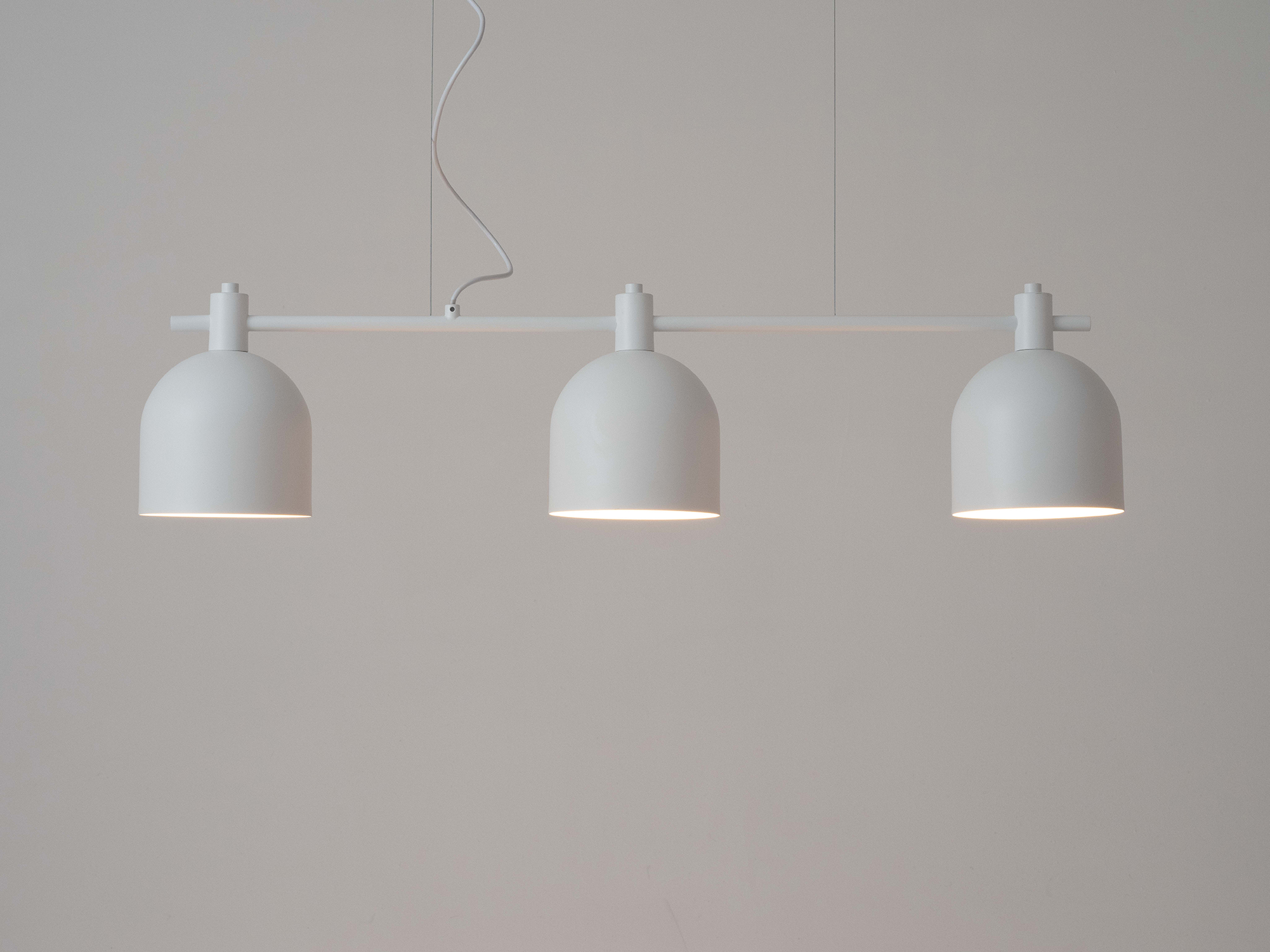 Front view of the Ilya large pendant lighting in white with light on