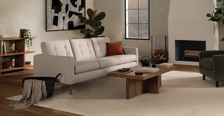 A beige sofa and walnut coffee table are displayed in a living room. Link to EQ3 canadian made upholstery