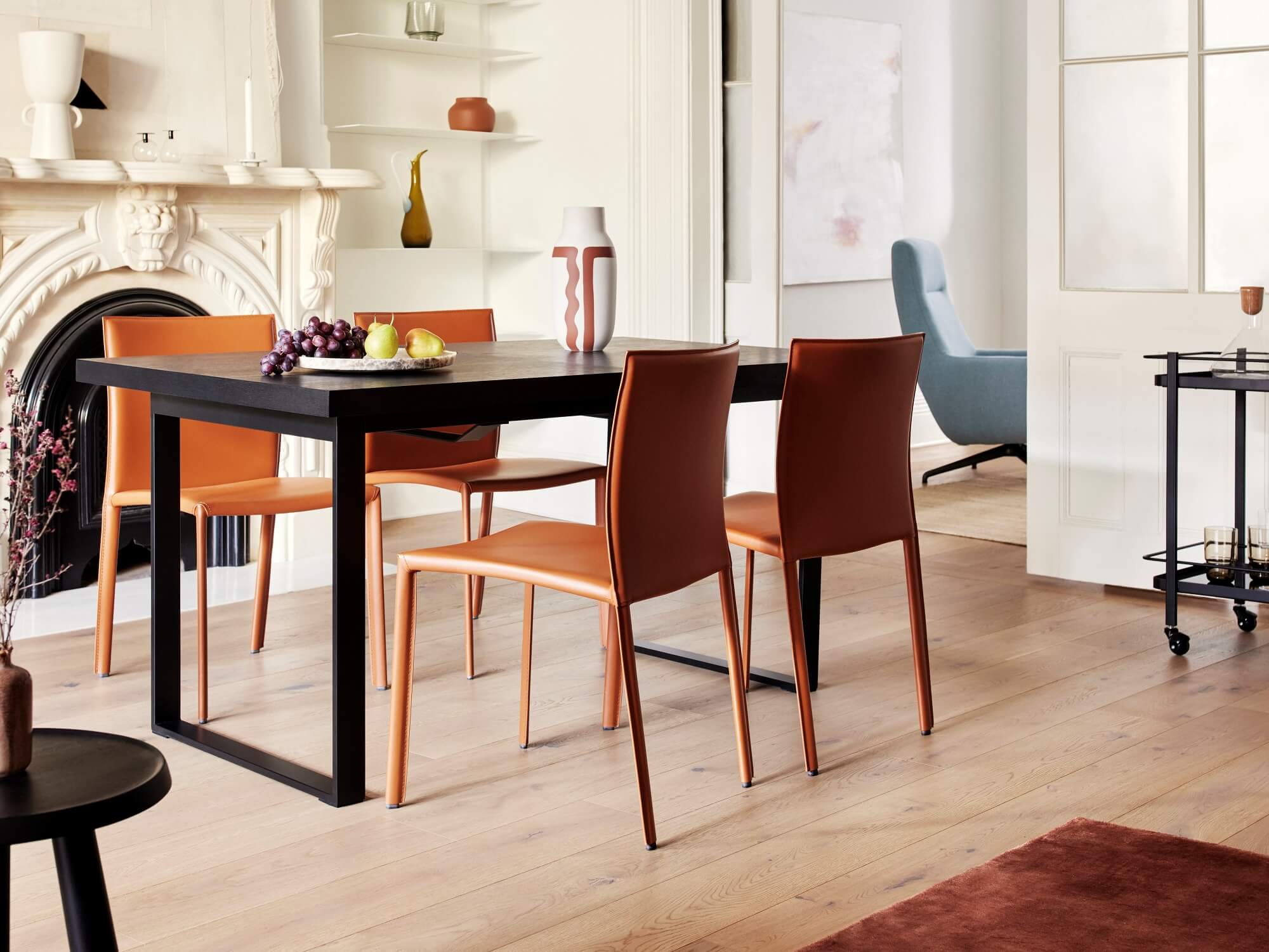 Brown dining chairs at round black dining table