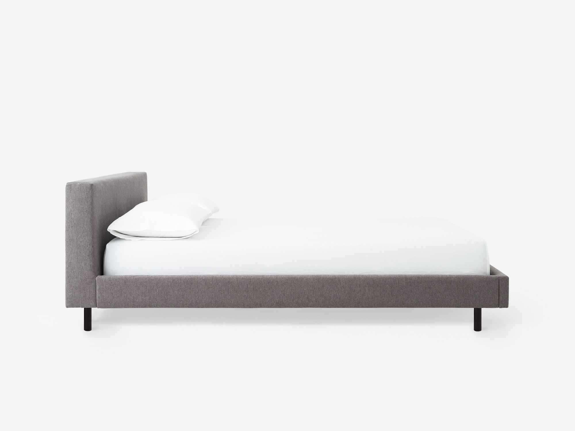 Side view of the Bento platform bed frame in grey fabric