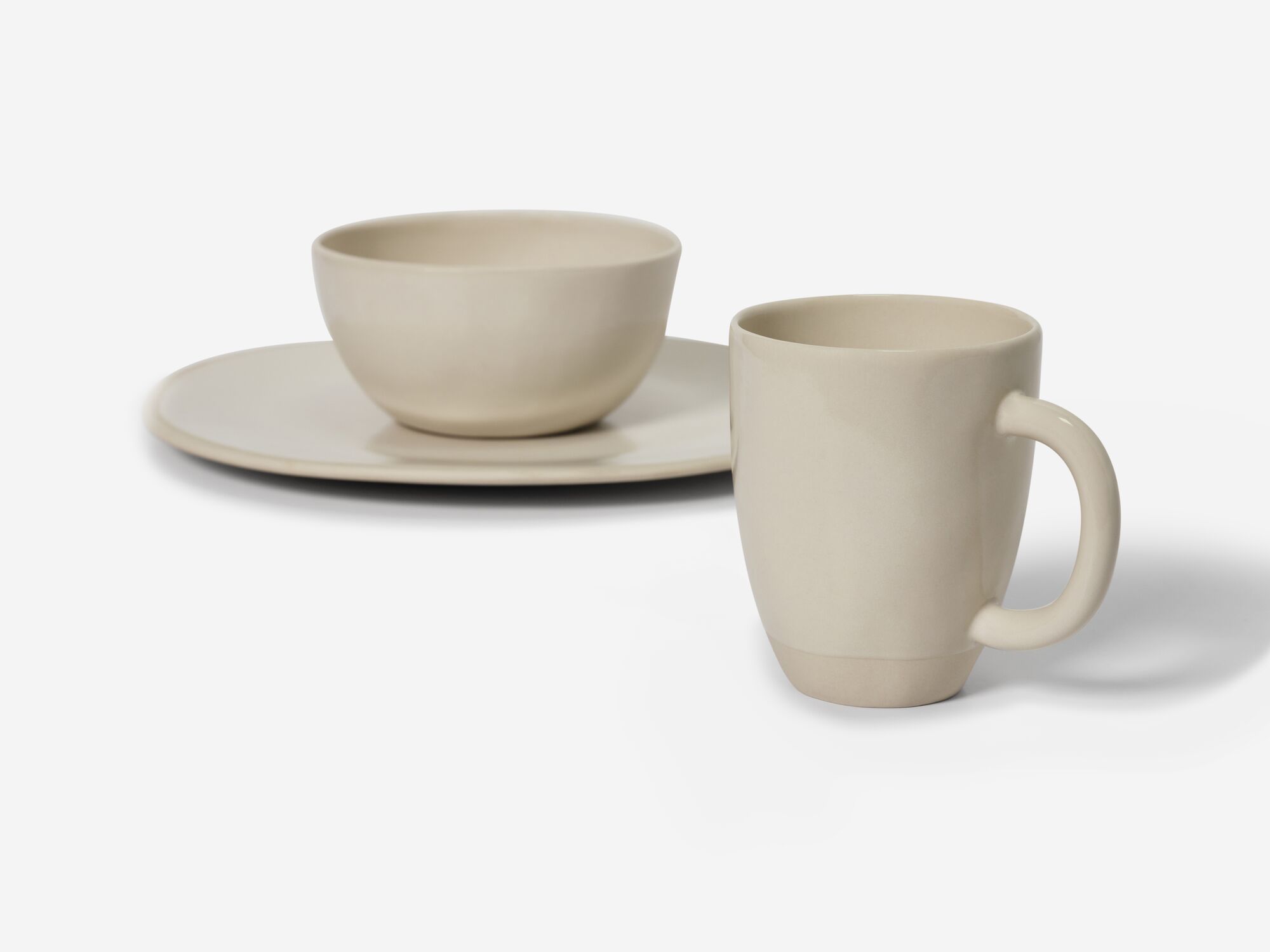 Beige stoneware mug and dishes front view