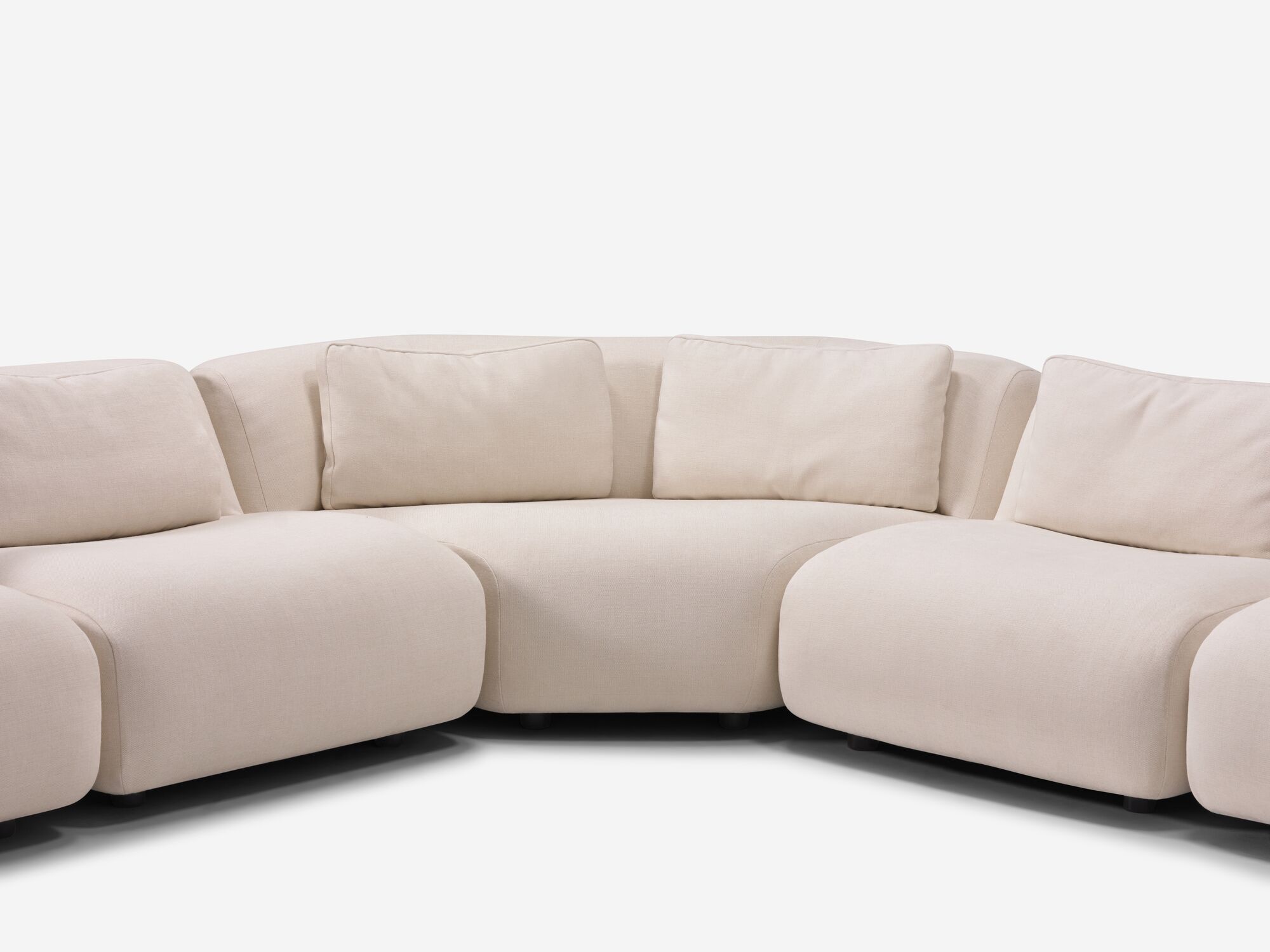 Corner detail view of beige curved sectional