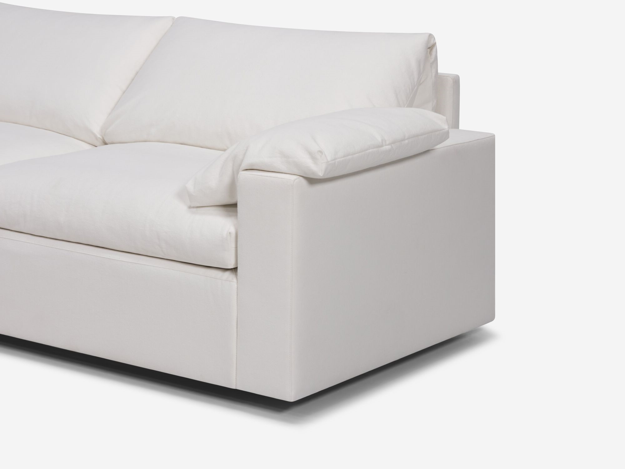 White sectional sofa with left hand chaise and pillow seat detail view