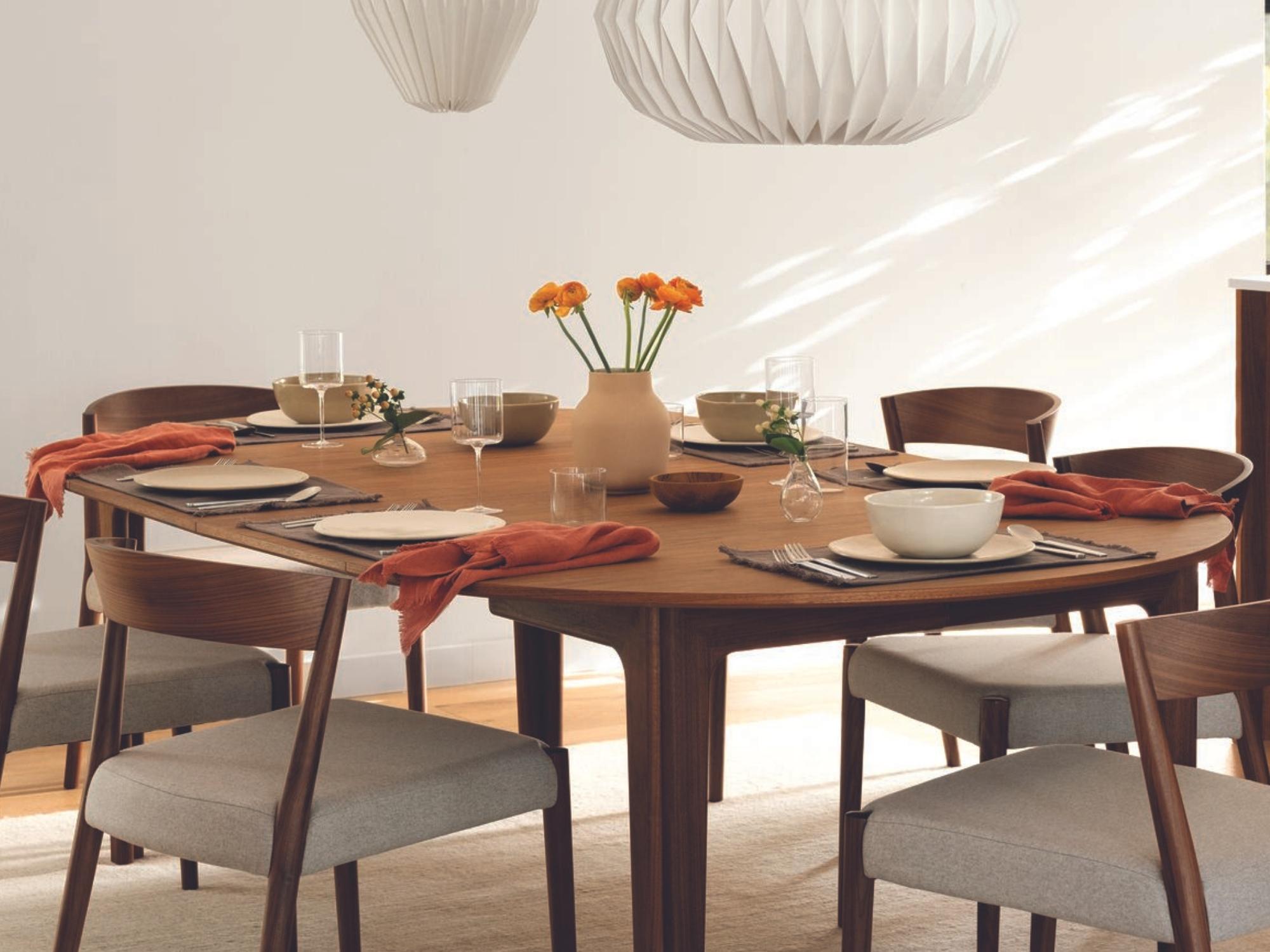 Grey placemats on walnut dining table with matching chairs