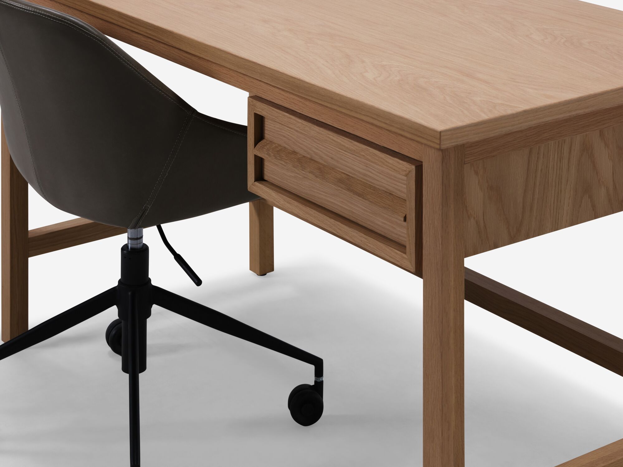 Detail view of oak desk with office chair