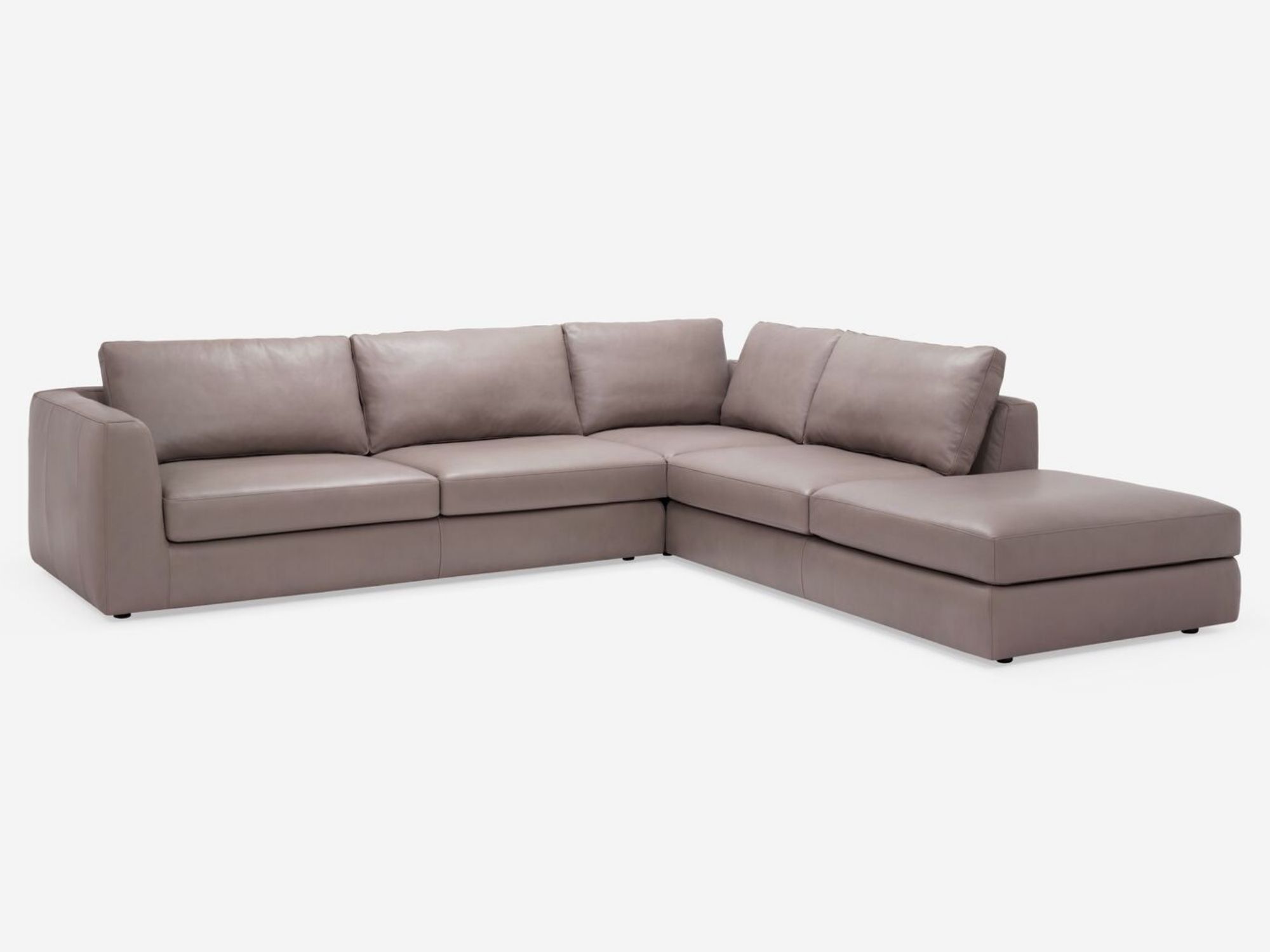 Front view of the modern sectional couch in beige leather with right hand chaise