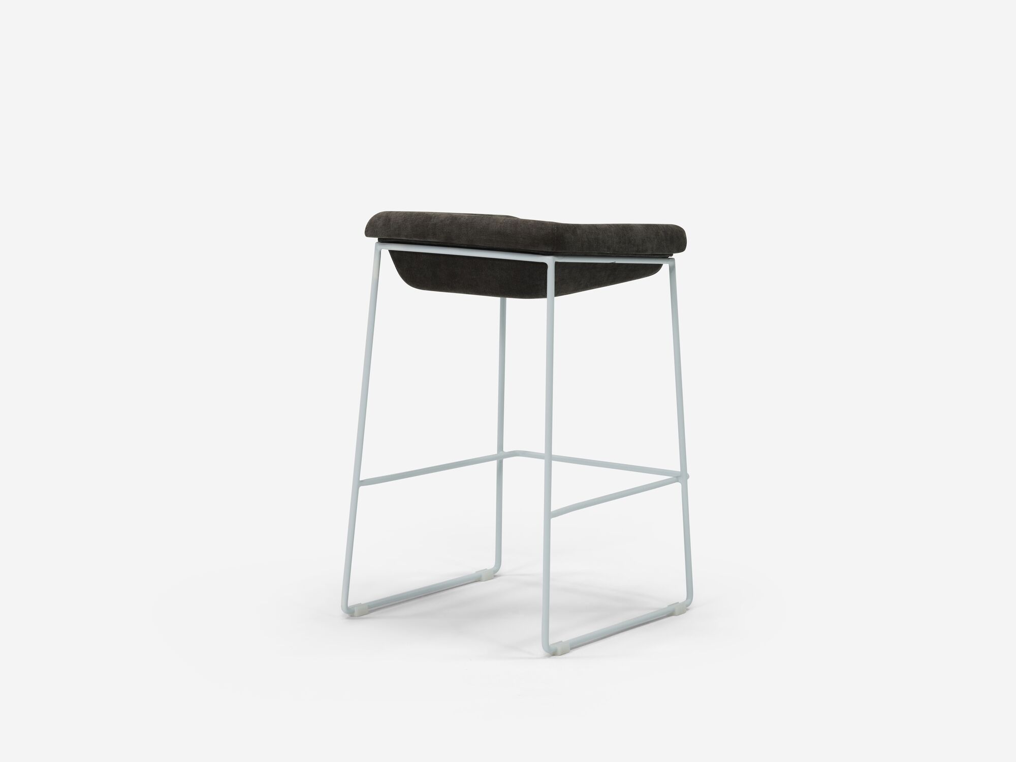 Counter stool with black seat and white legs back angle view