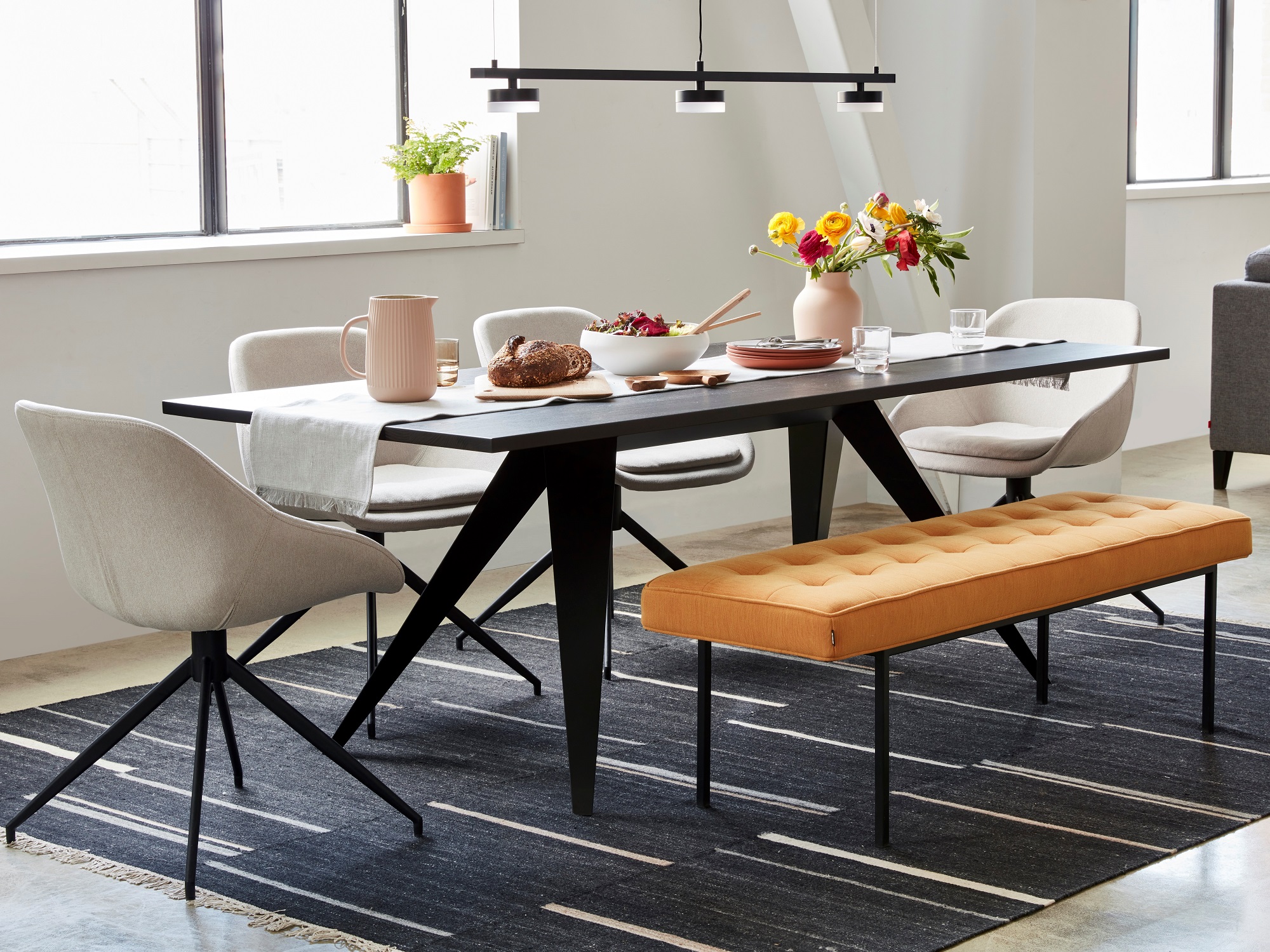 Orange fabric dining bench at modern dining table