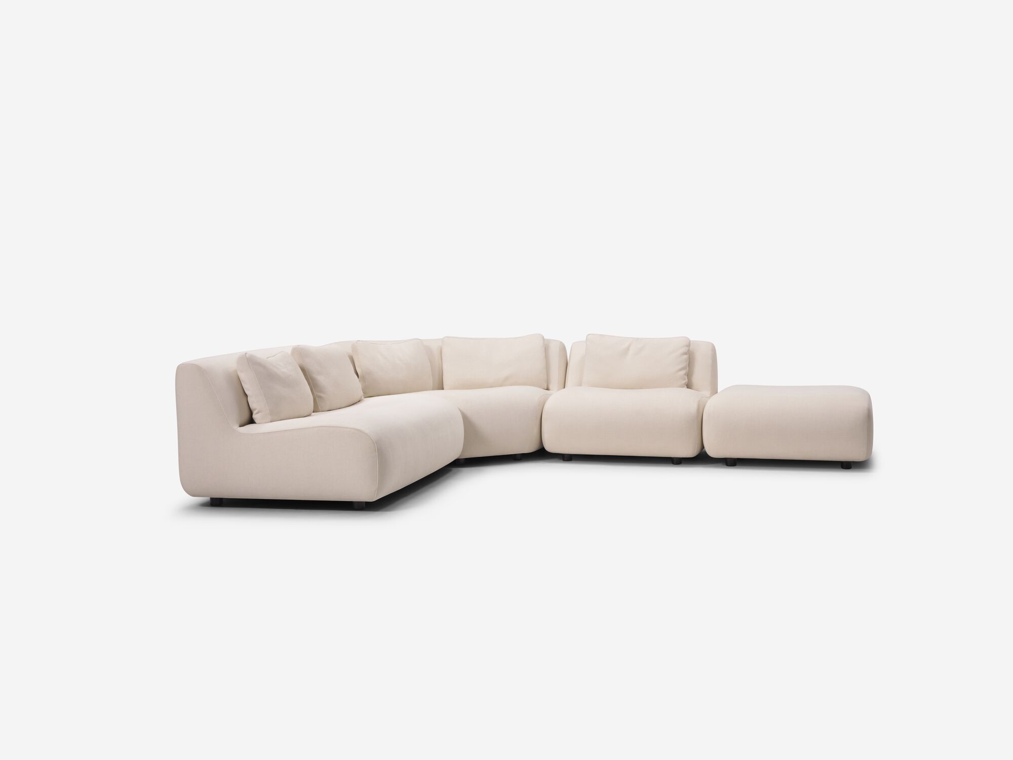 Angle view of beige armless sectional sofa