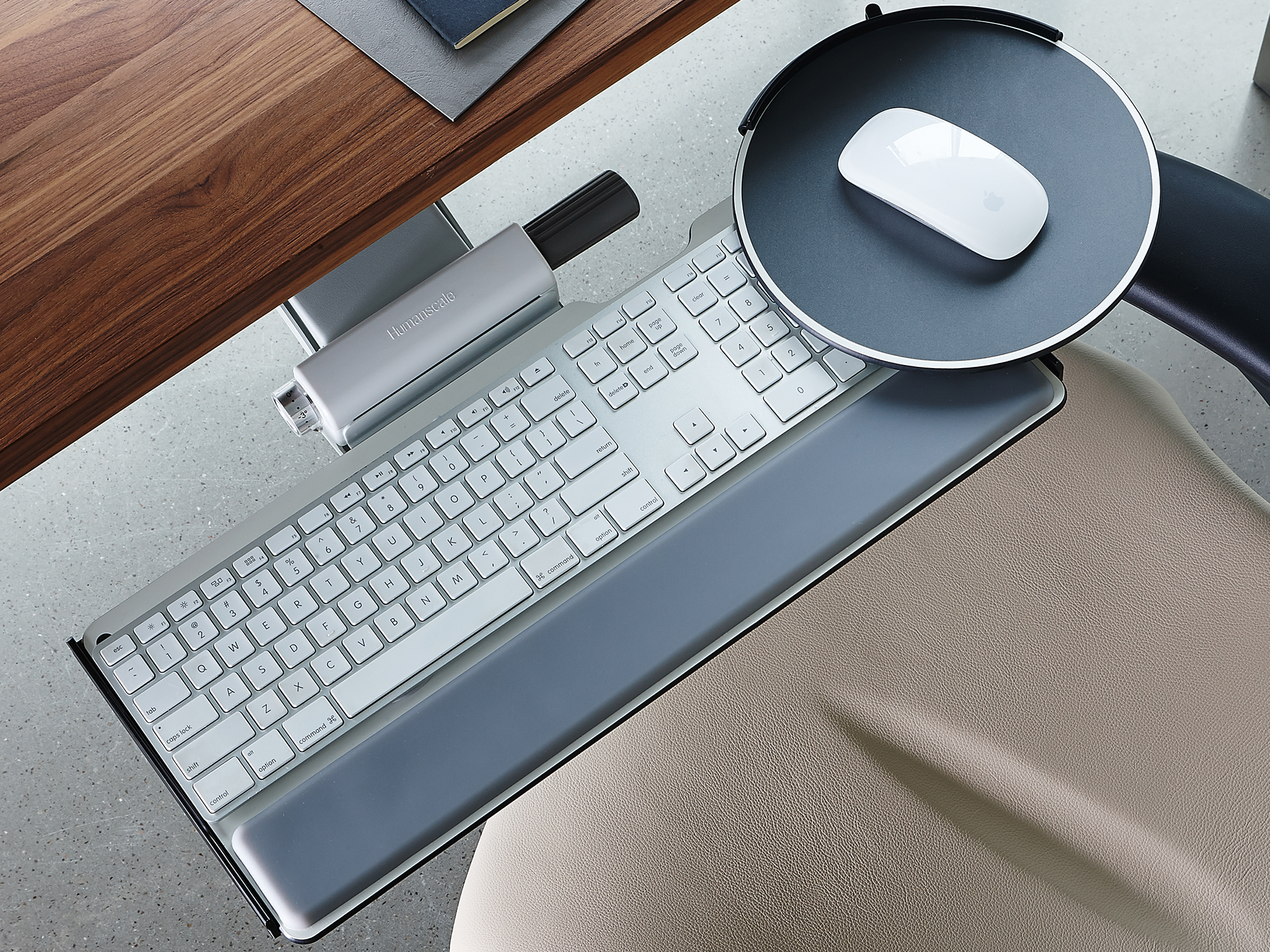 Top view of the Humanscale under desk keyboard tray in white with keyboard and mouse on it