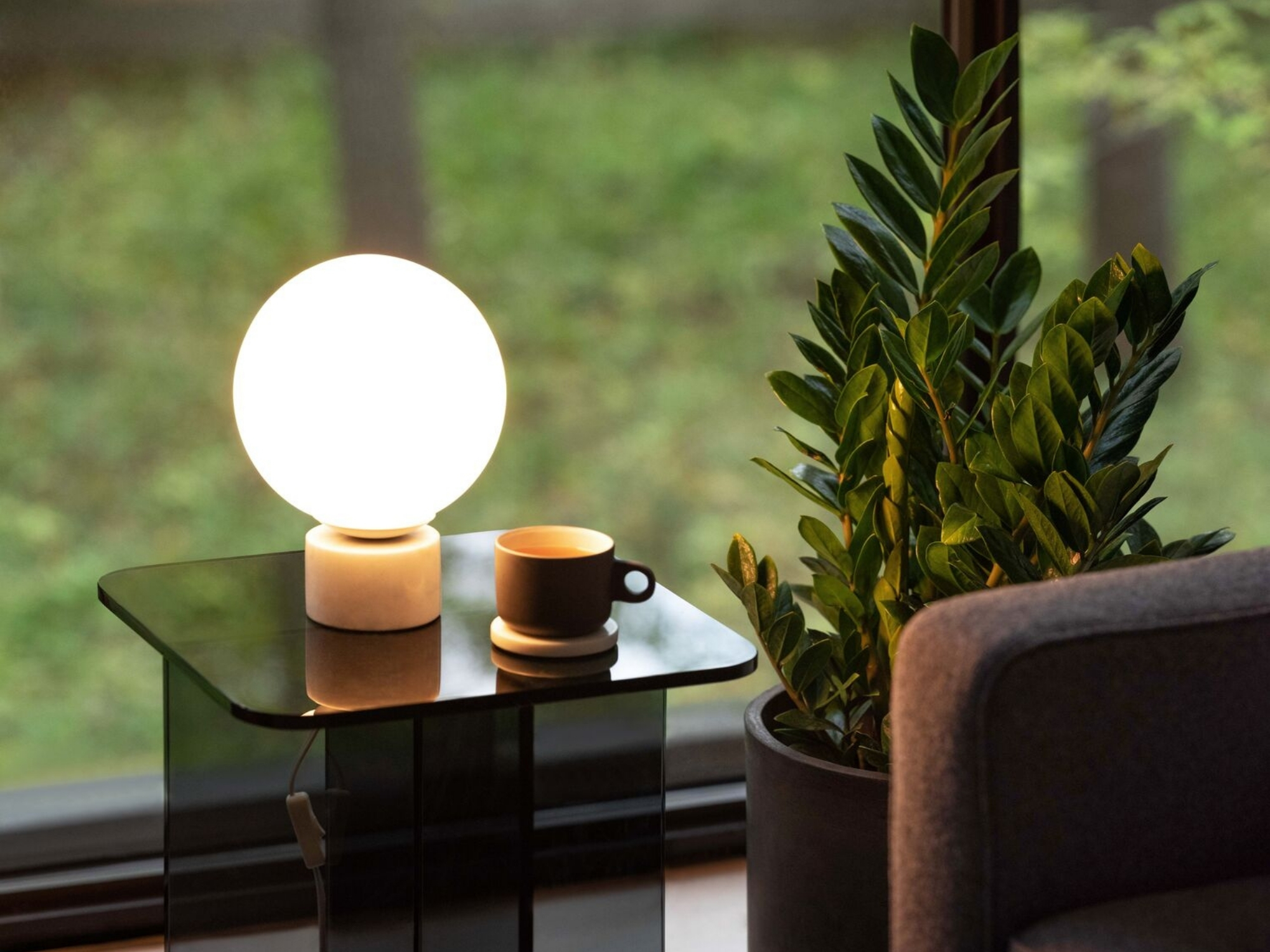 Round white marble table lamp on glass end table