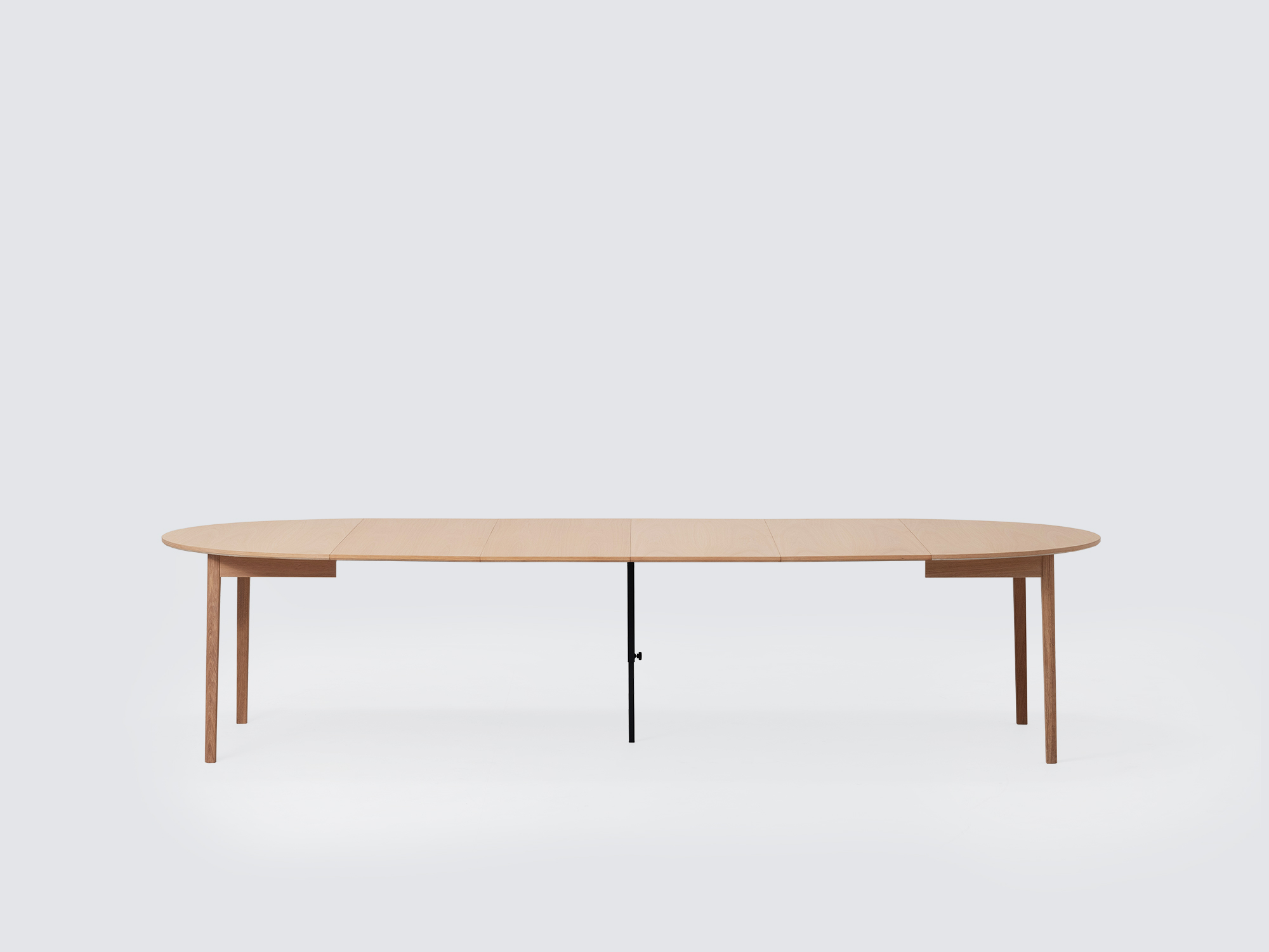 Side view of the large expanded Ease Expandable Dining Table in oak