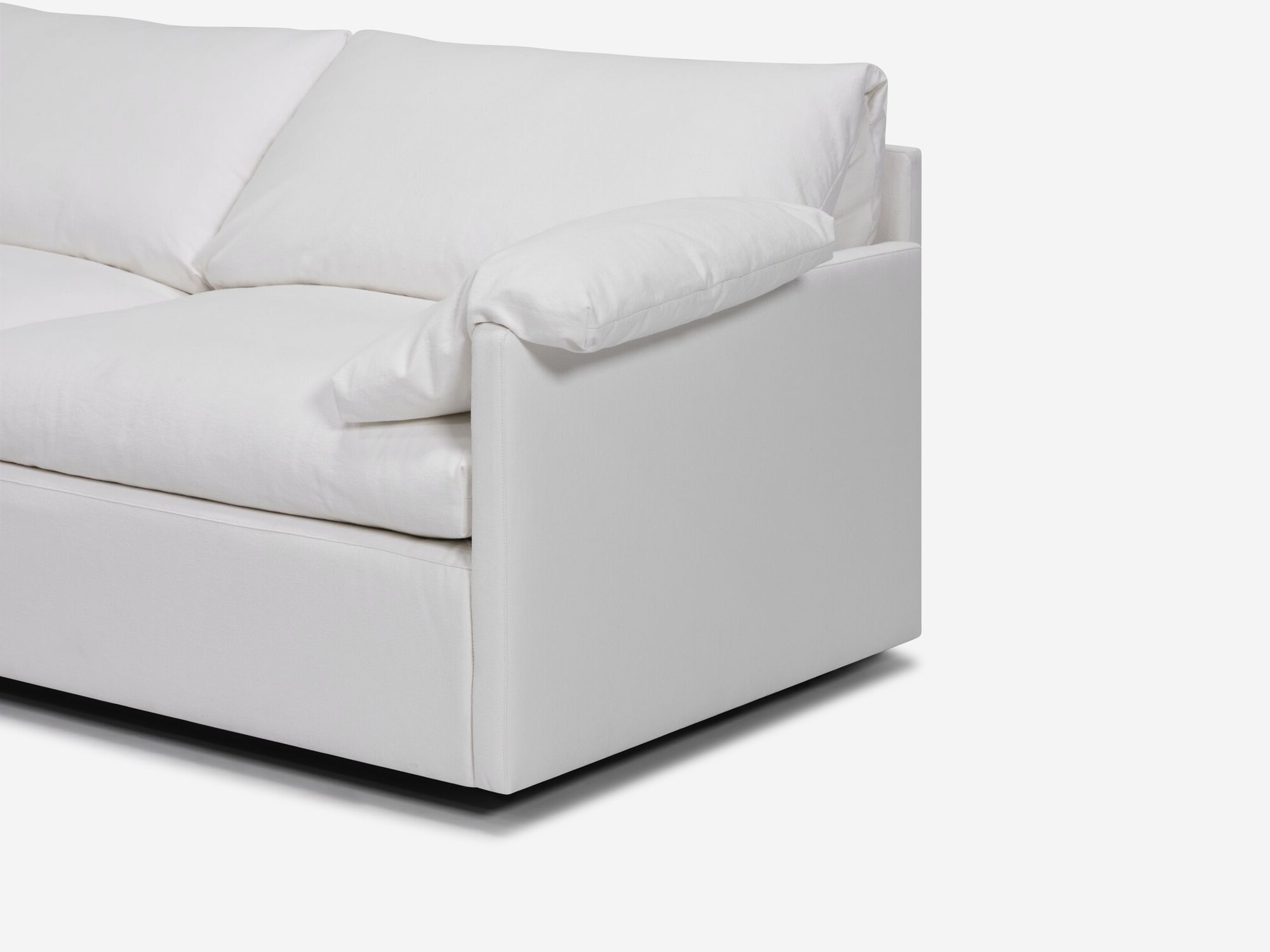 White sectional sofa with narrow arms and pillow angle detail view