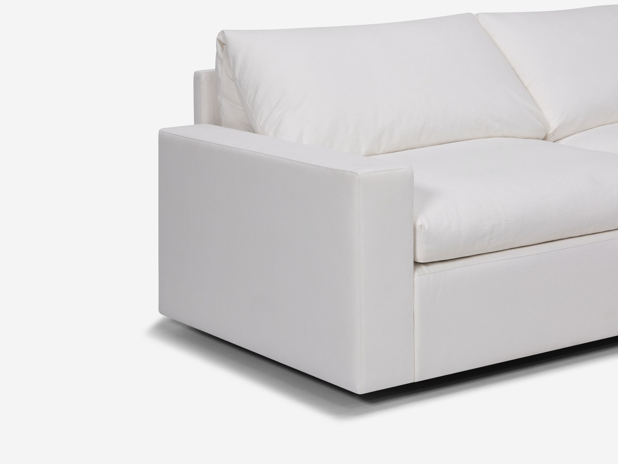 Seat detail view of white sectional sofa with right hand chaise