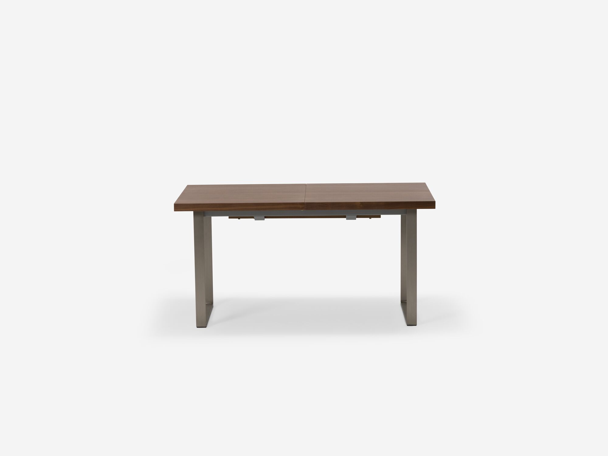 Side view of expandable dining table with stainless steel legs and walnut top