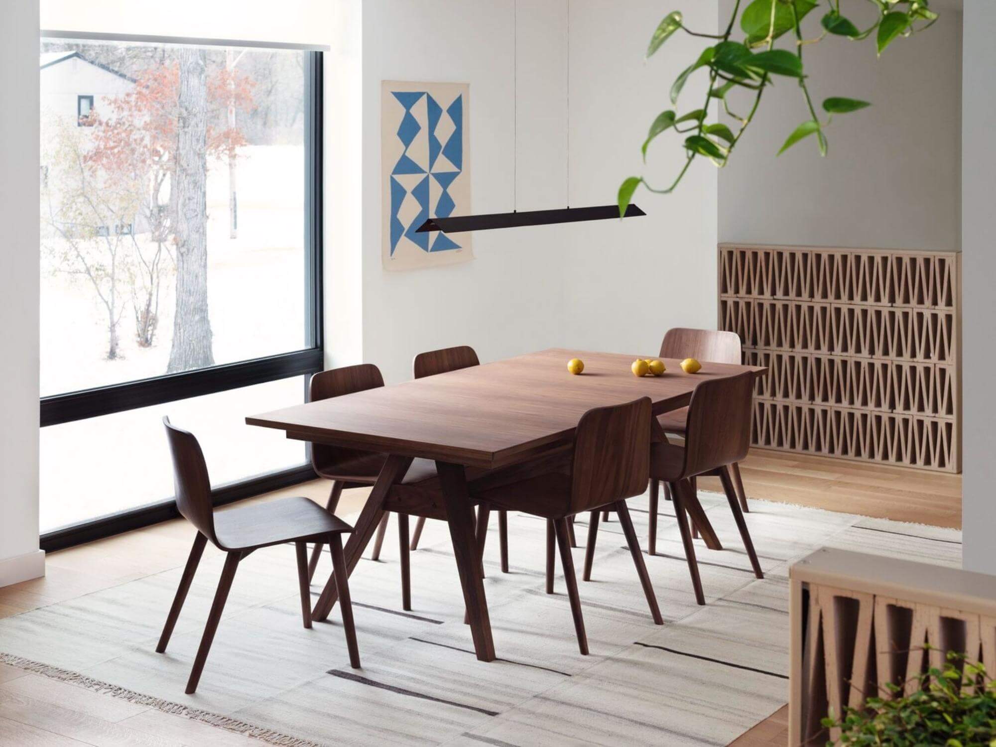 Beige striped rug under walnut dining set in dining room