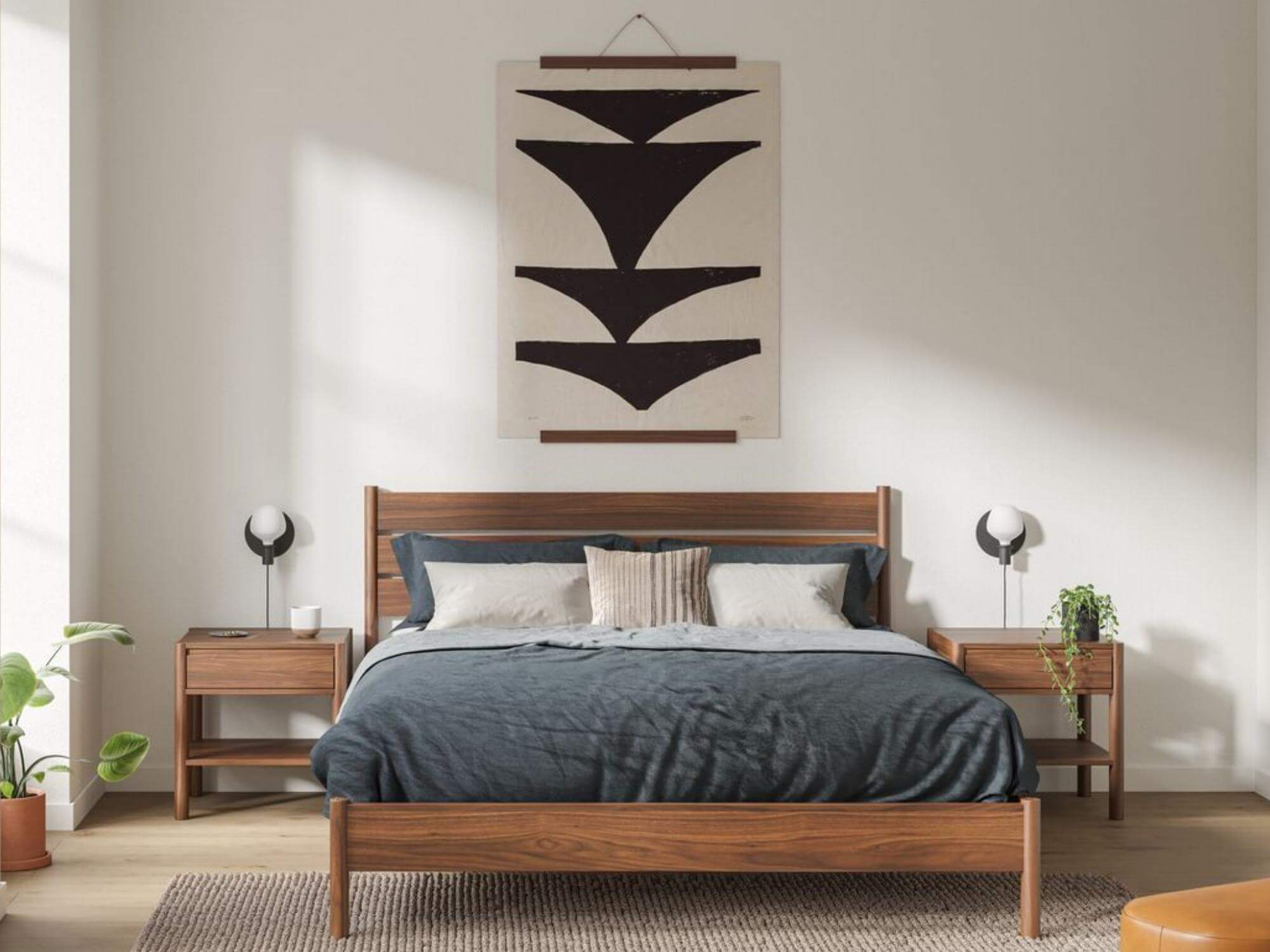 Walnut poster hanger with canvas print above bed of mid century modern bedroom