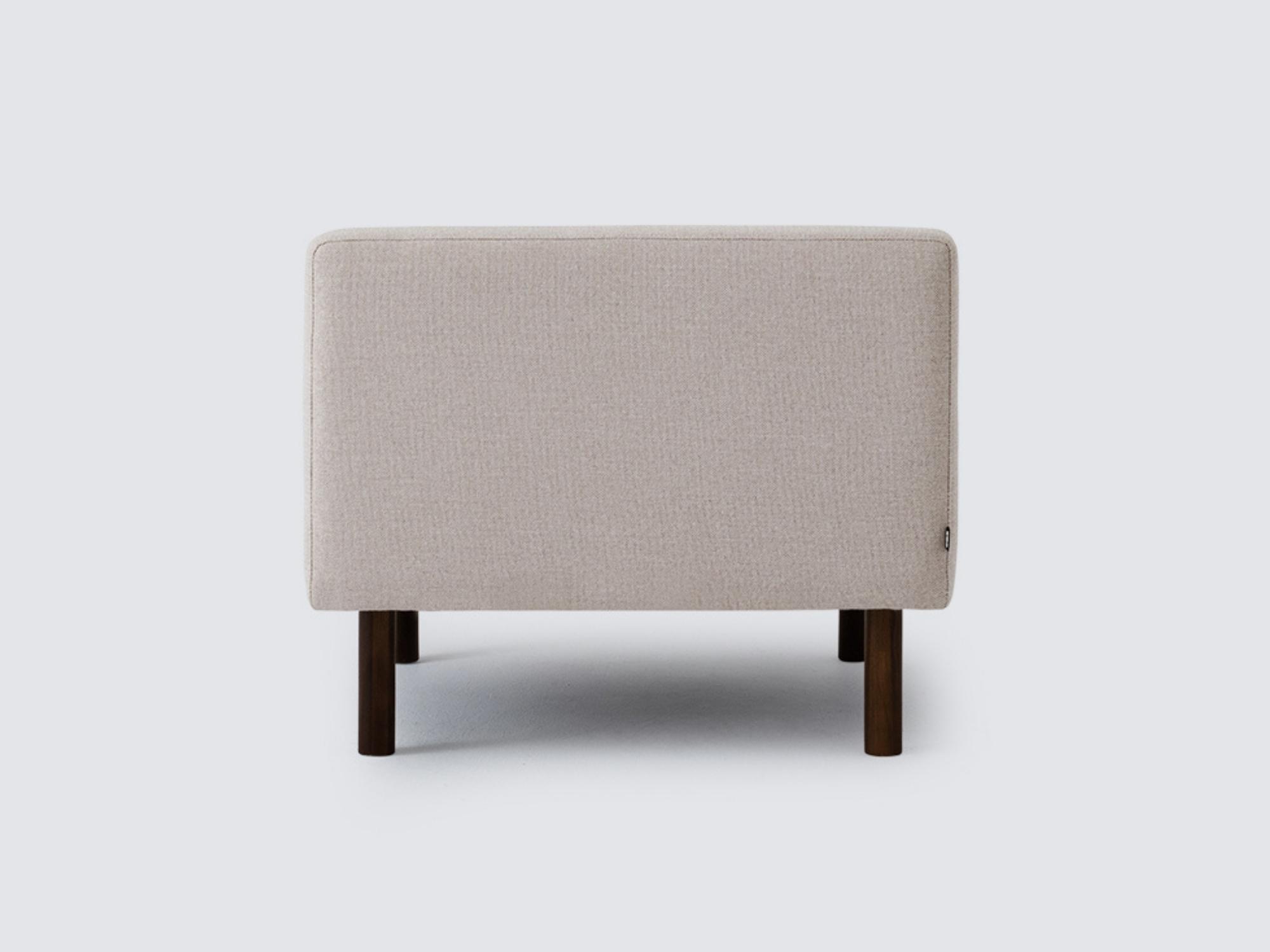 Back view of the Joan extended chair upholstered in beige fabric